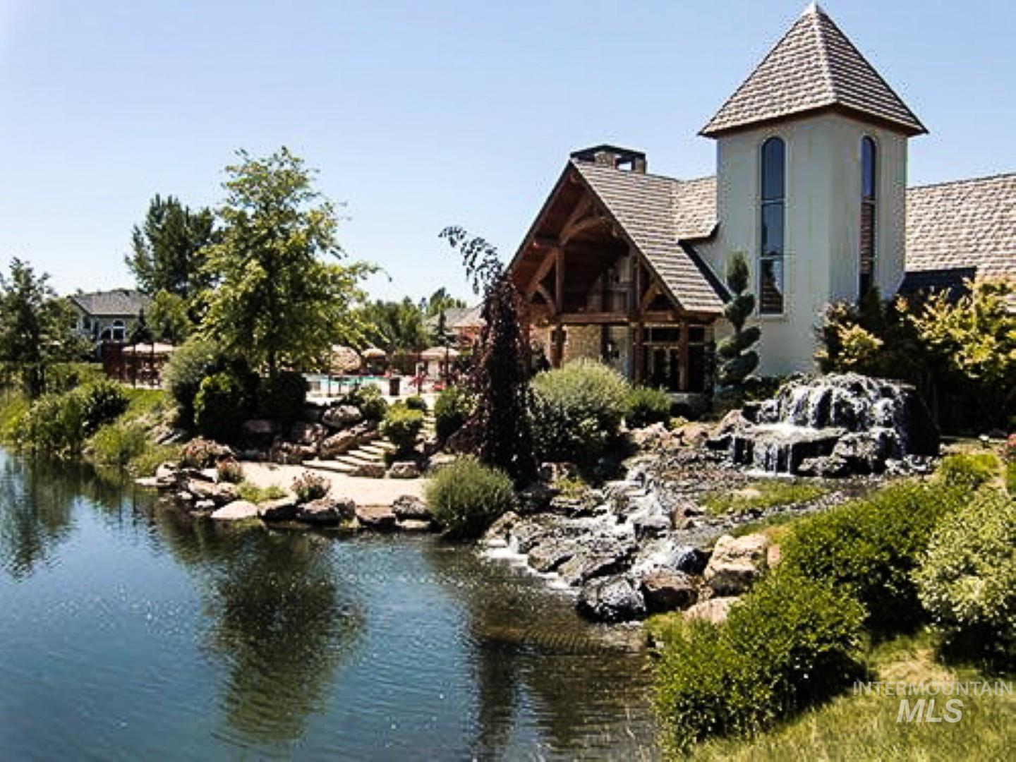 Back of house featuring stucco siding and a water view