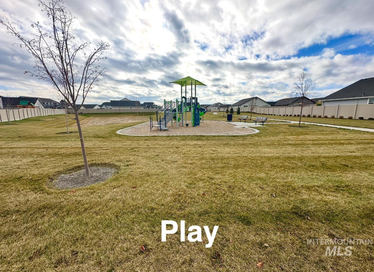 Communal playground with a residential view and a patio area
