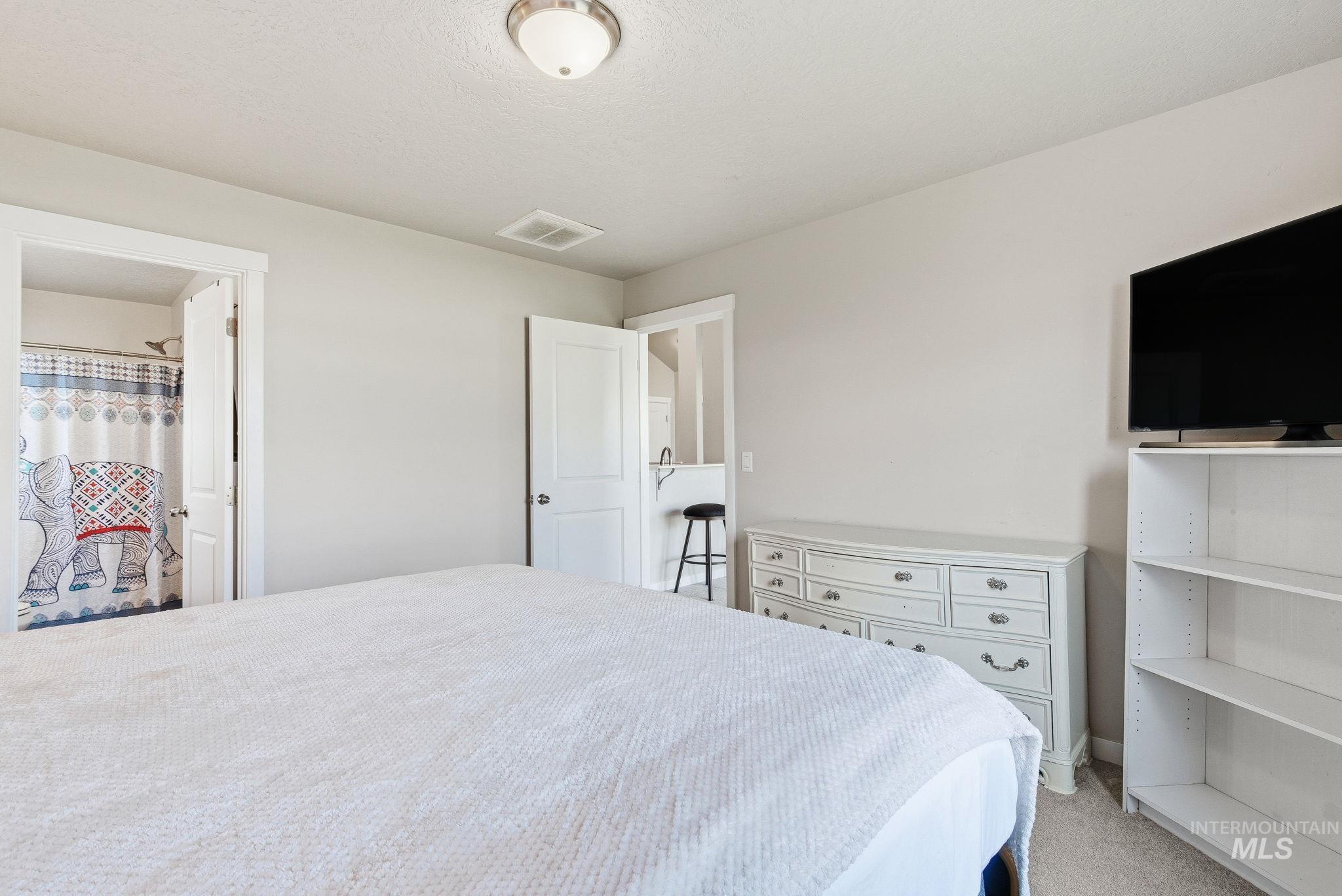 Bedroom with light carpet