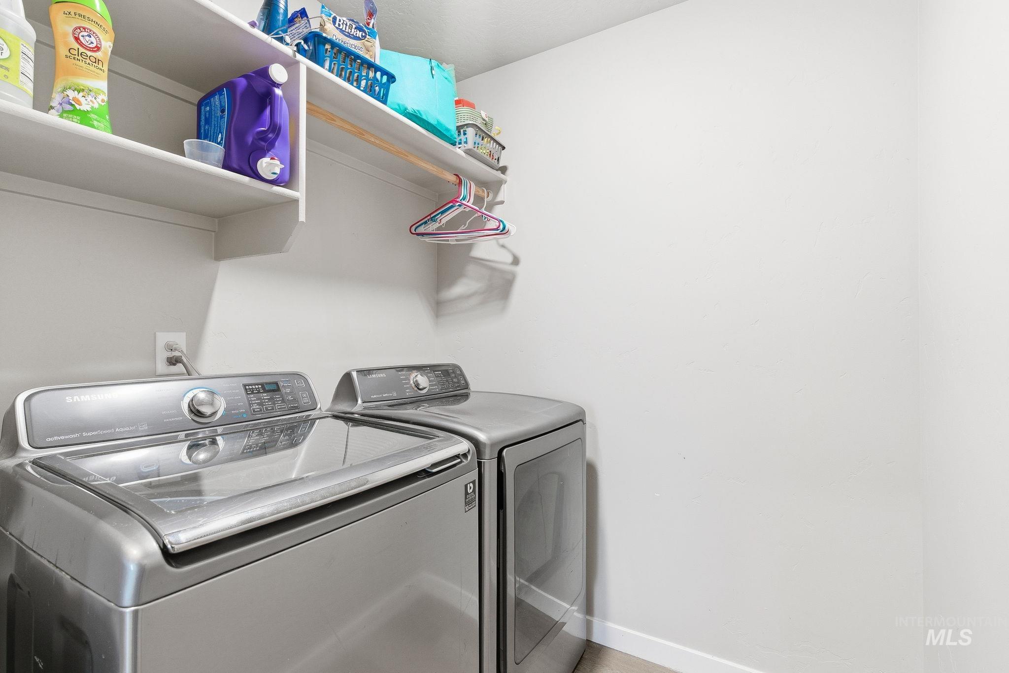 Laundry room featuring separate washer and dryer and baseboards