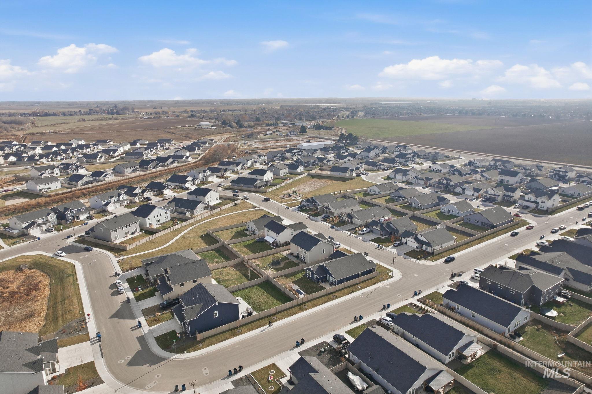 Aerial view of property's location with nearby suburban area