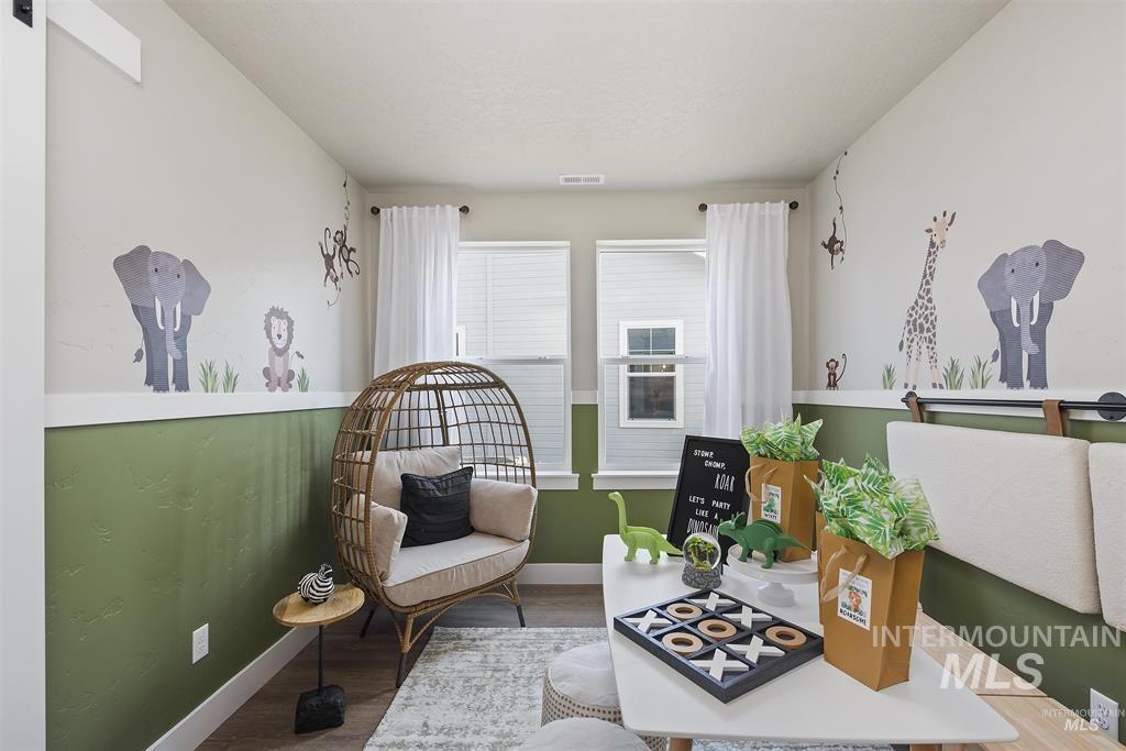 Living area featuring wood finished floors and baseboards