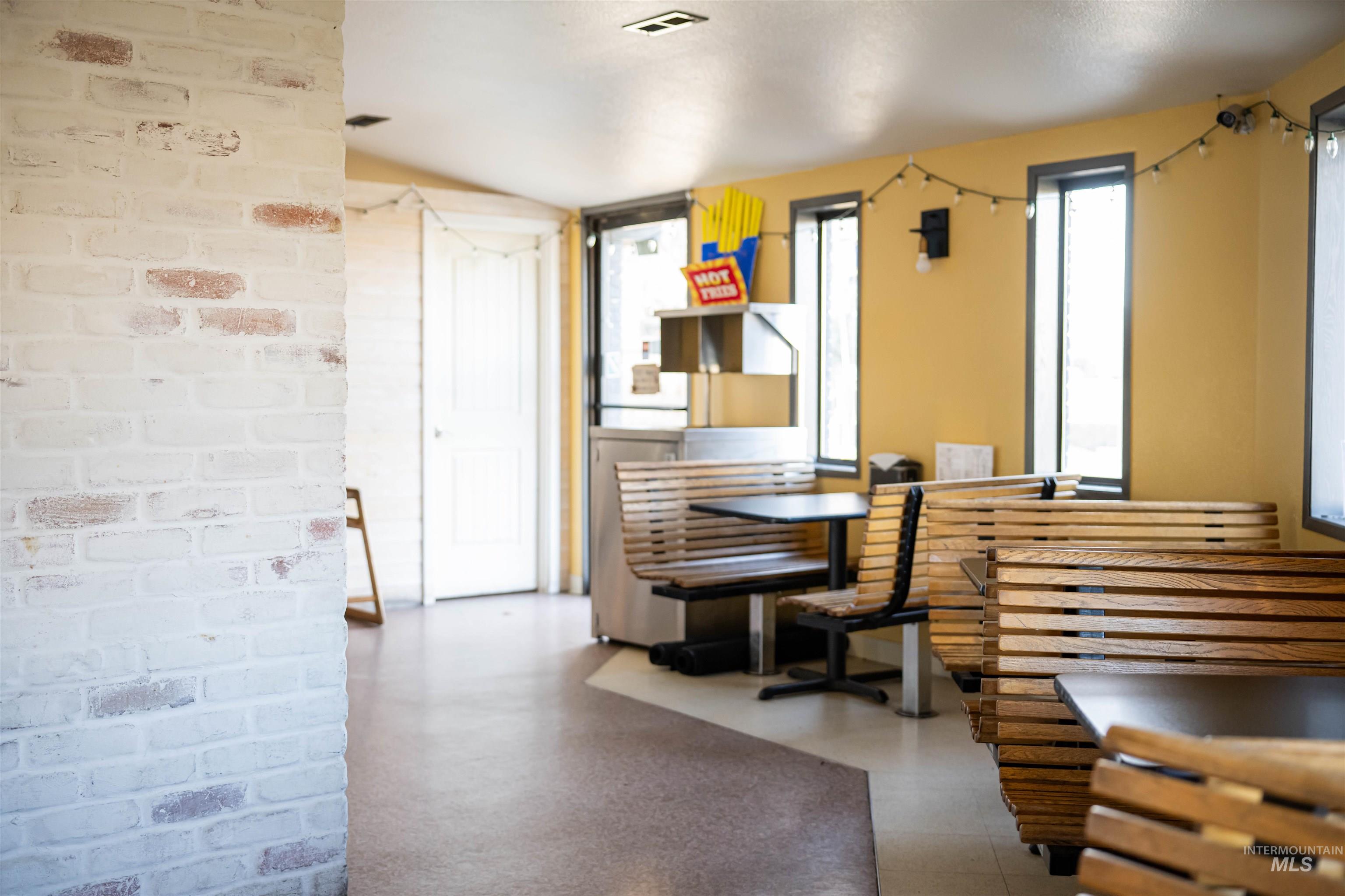 Dining room with brick wall and tile patterned floors