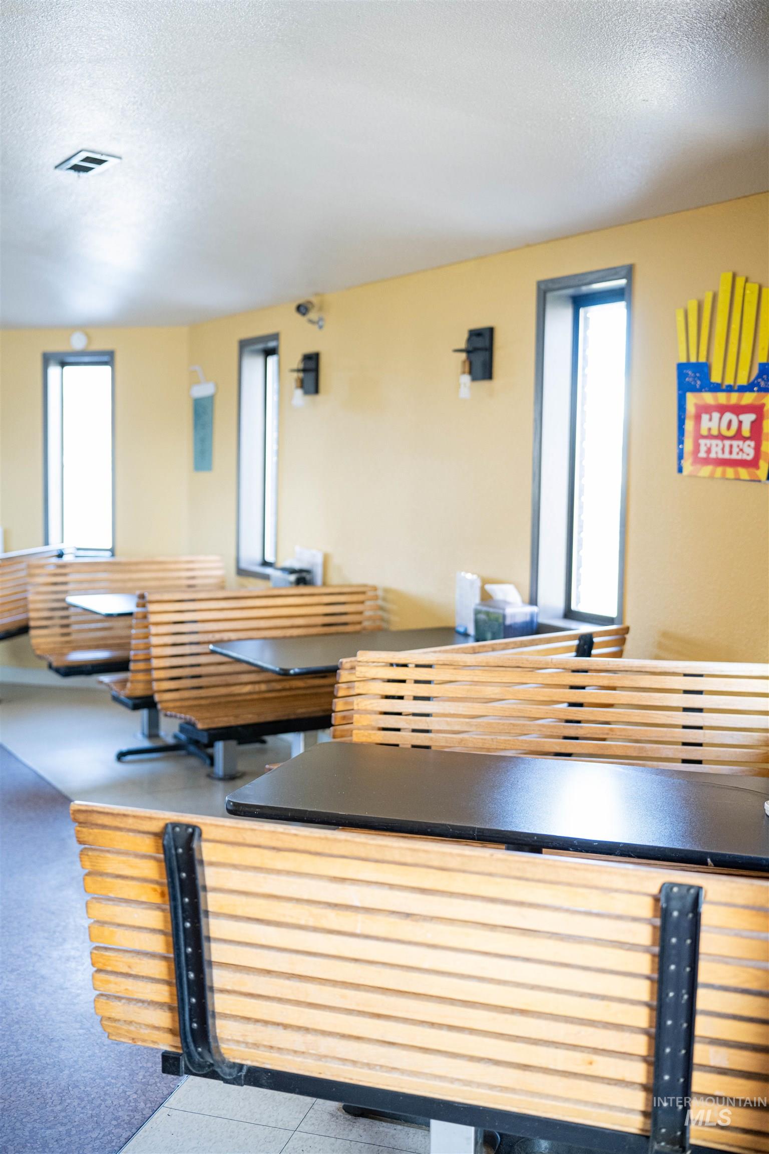 Dining space featuring a textured ceiling and healthy amount of natural light