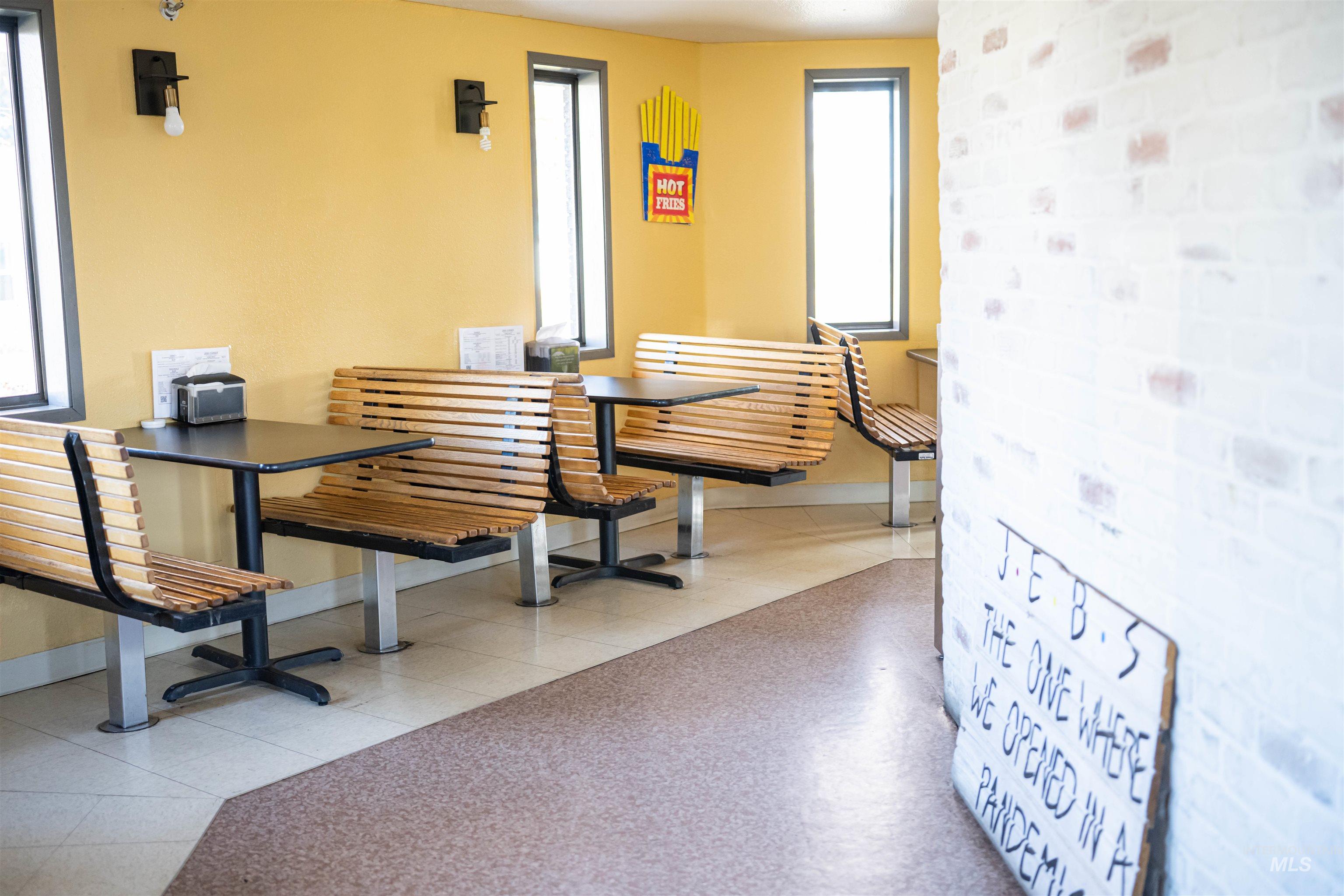 Dining room with brick wall and light tile patterned flooring