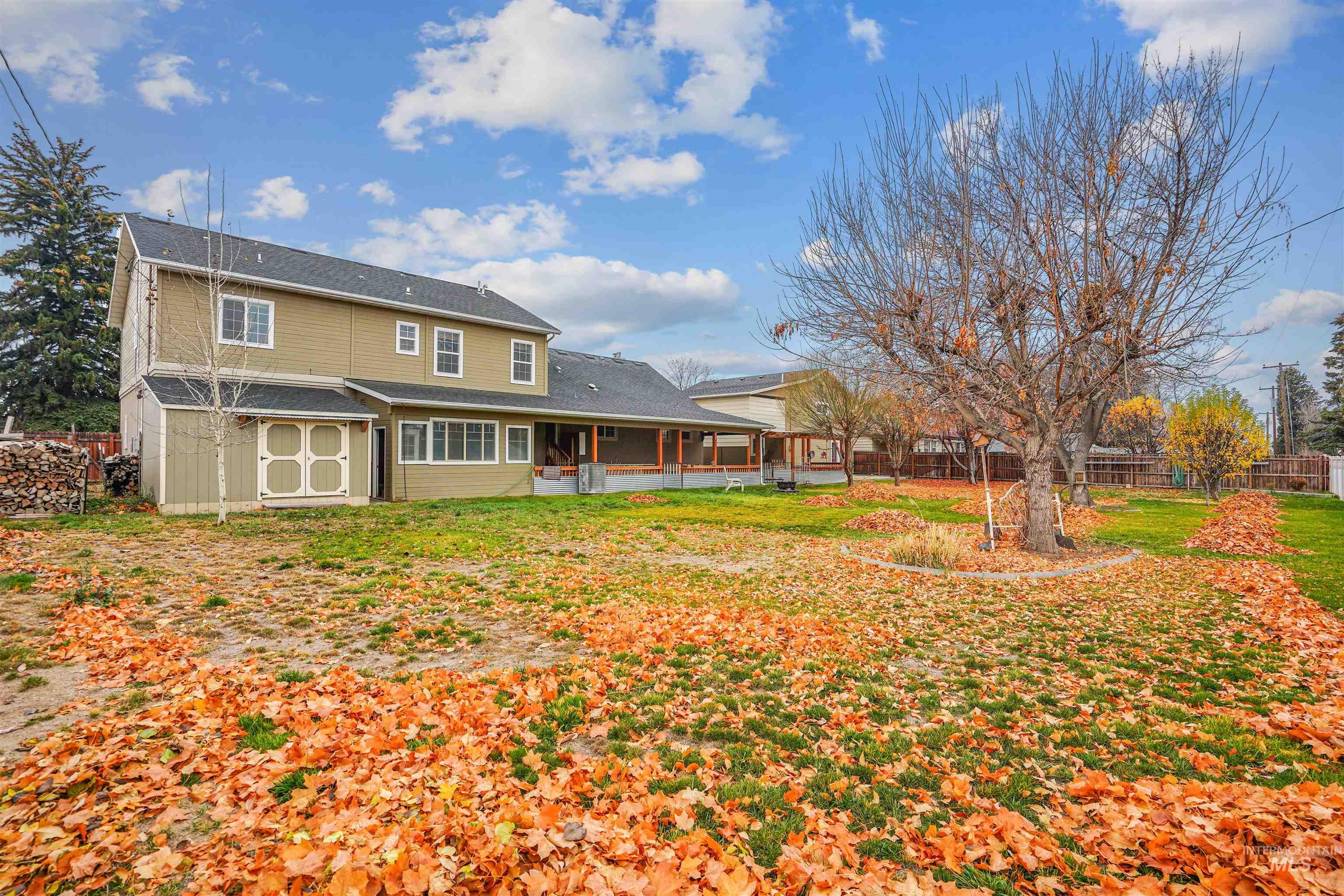 Rear view of property with a sunroom and an outdoor structure