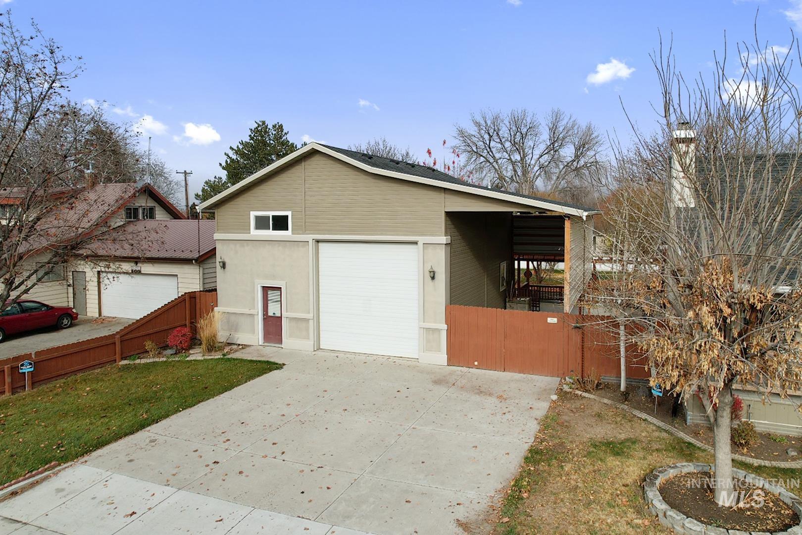 View of property exterior with driveway and a chimney