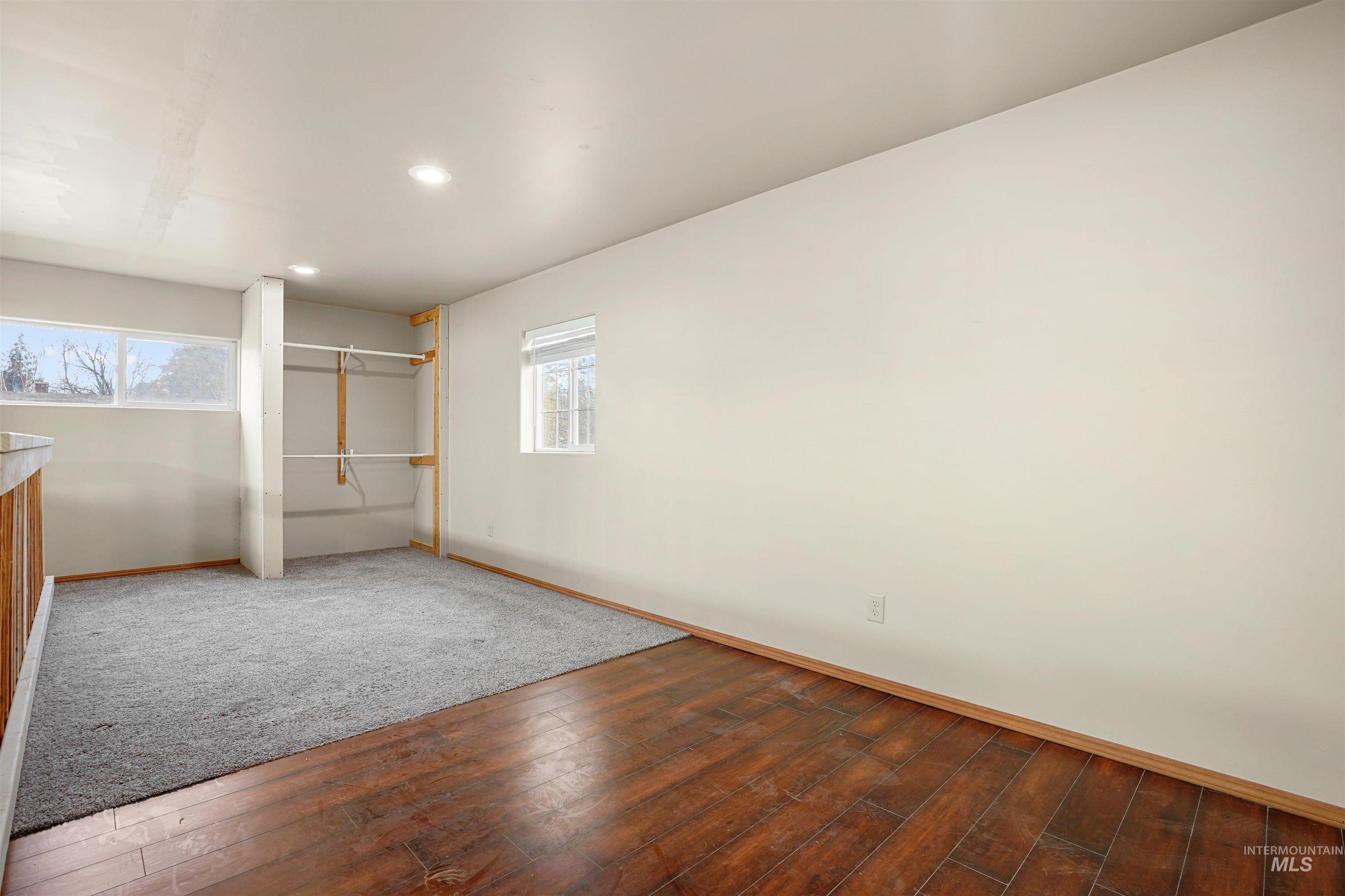 Unfurnished bedroom featuring a closet, wood-type flooring, and recessed lighting