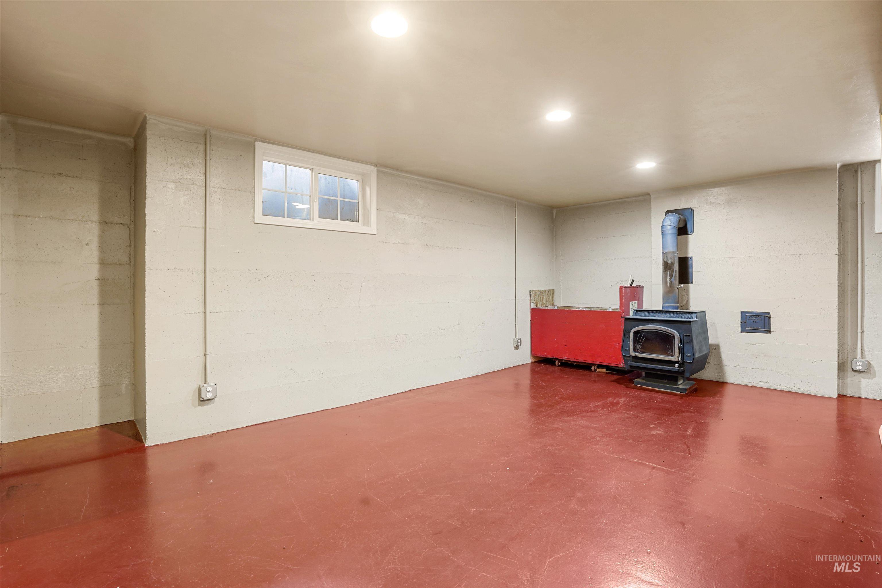 Finished below grade area featuring a wood stove
