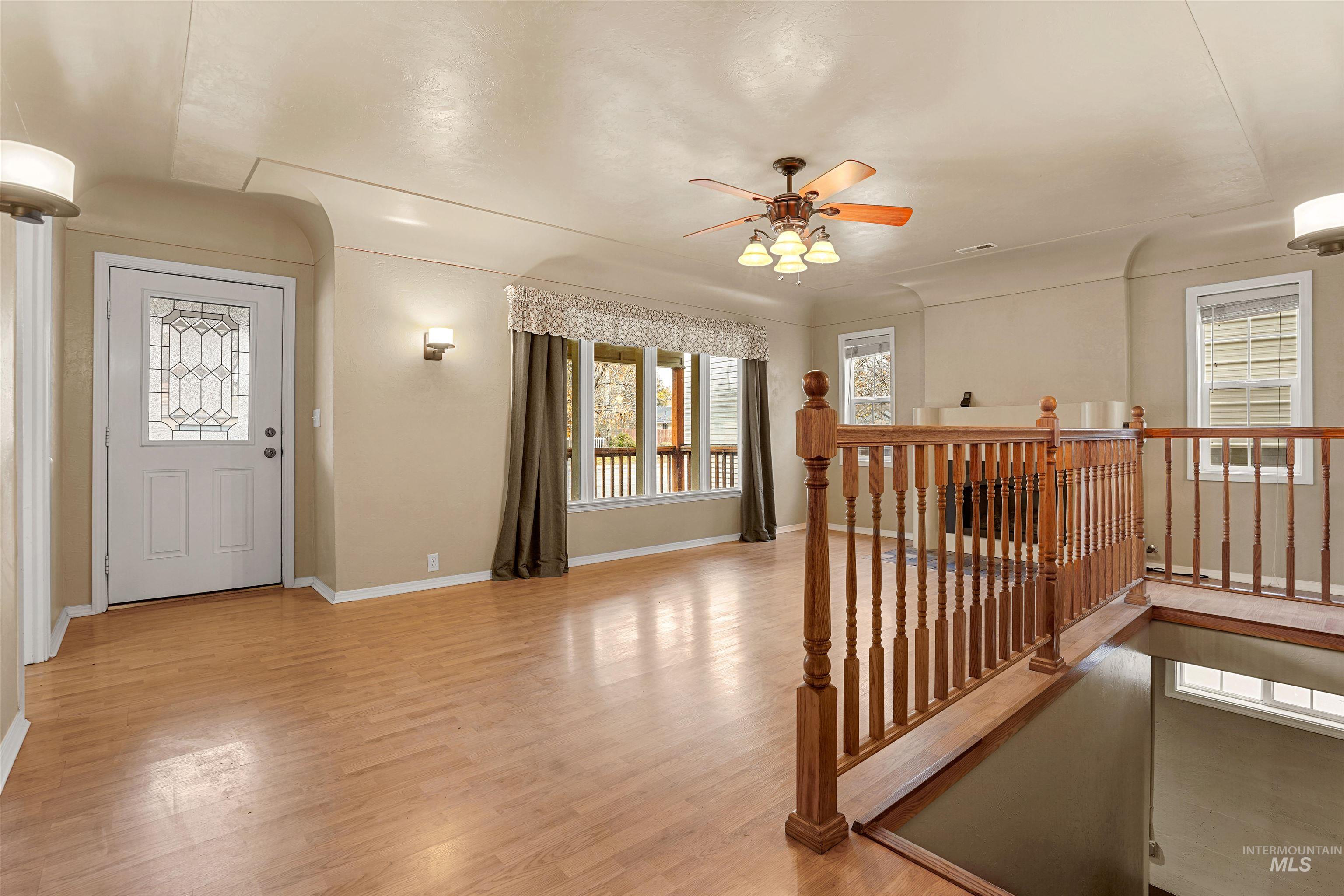 Entrance foyer featuring a ceiling fan and light wood finished floors