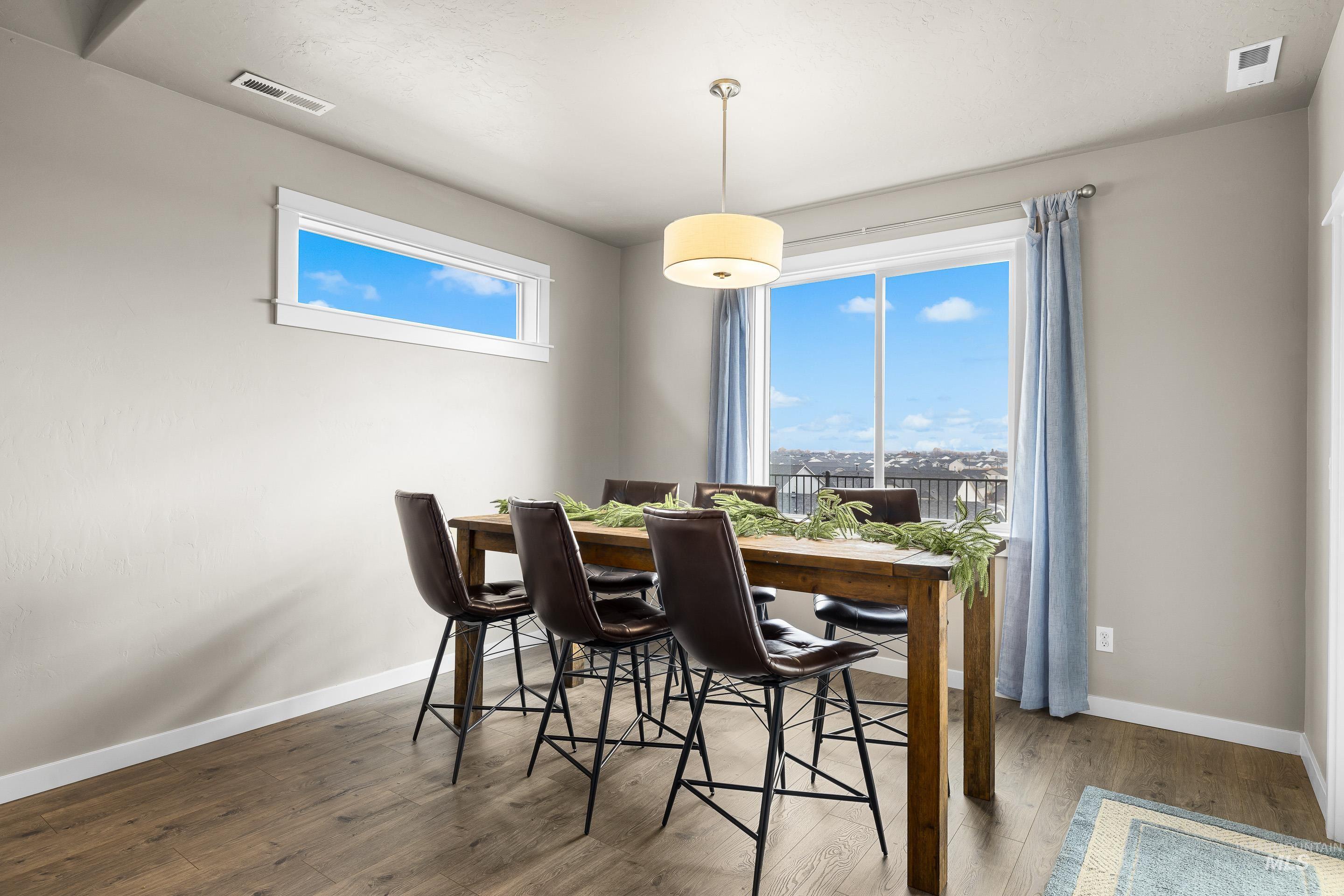 Dining area featuring wood-type flooring and baseboards