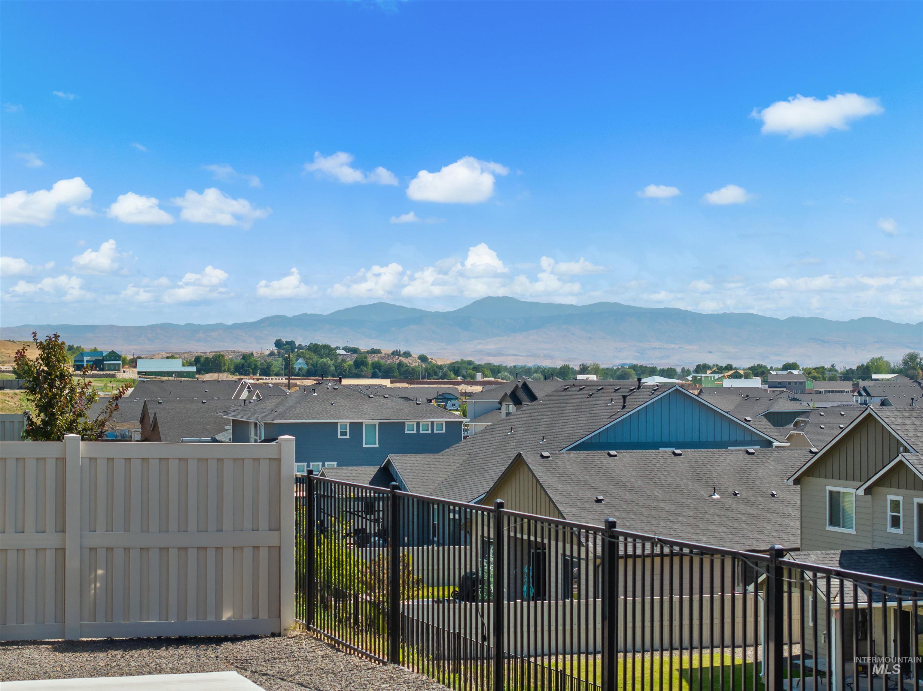View of mountain backdrop featuring nearby suburban area