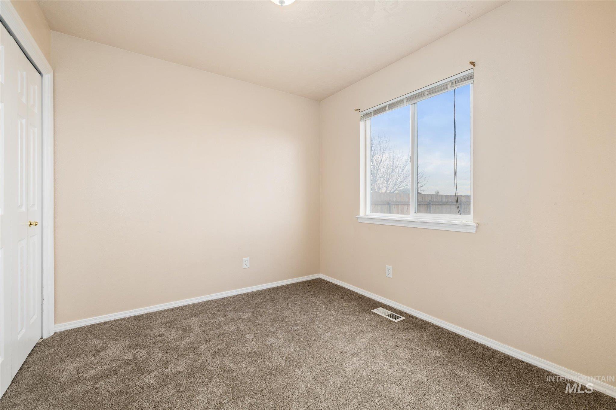 Unfurnished bedroom featuring a closet and carpet floors