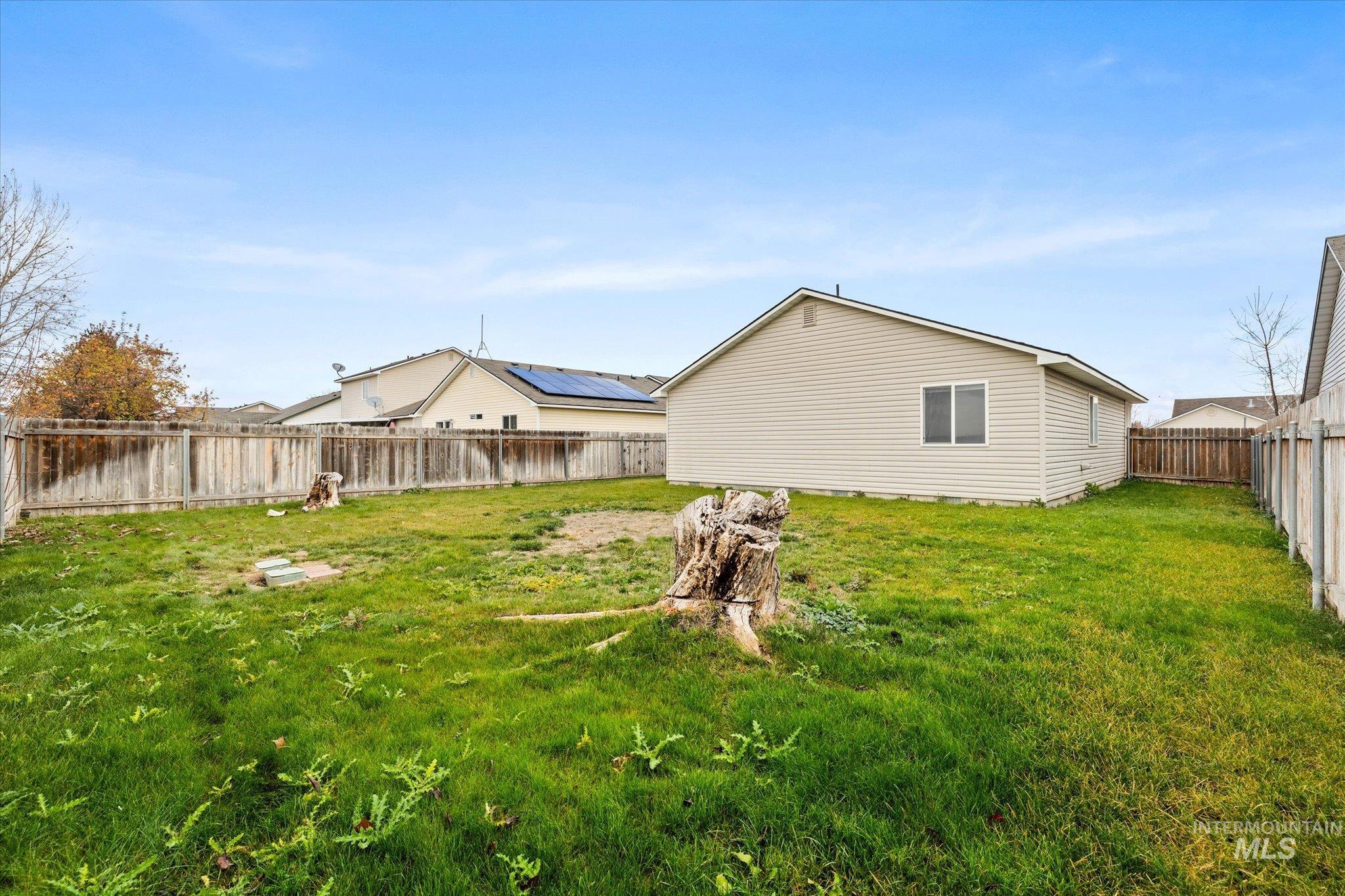 Back of house with a fenced backyard