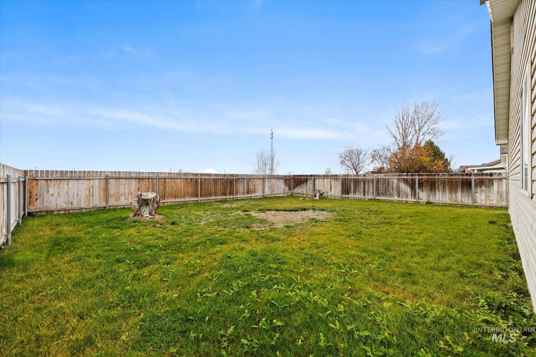 View of fenced backyard, and no back neighbors