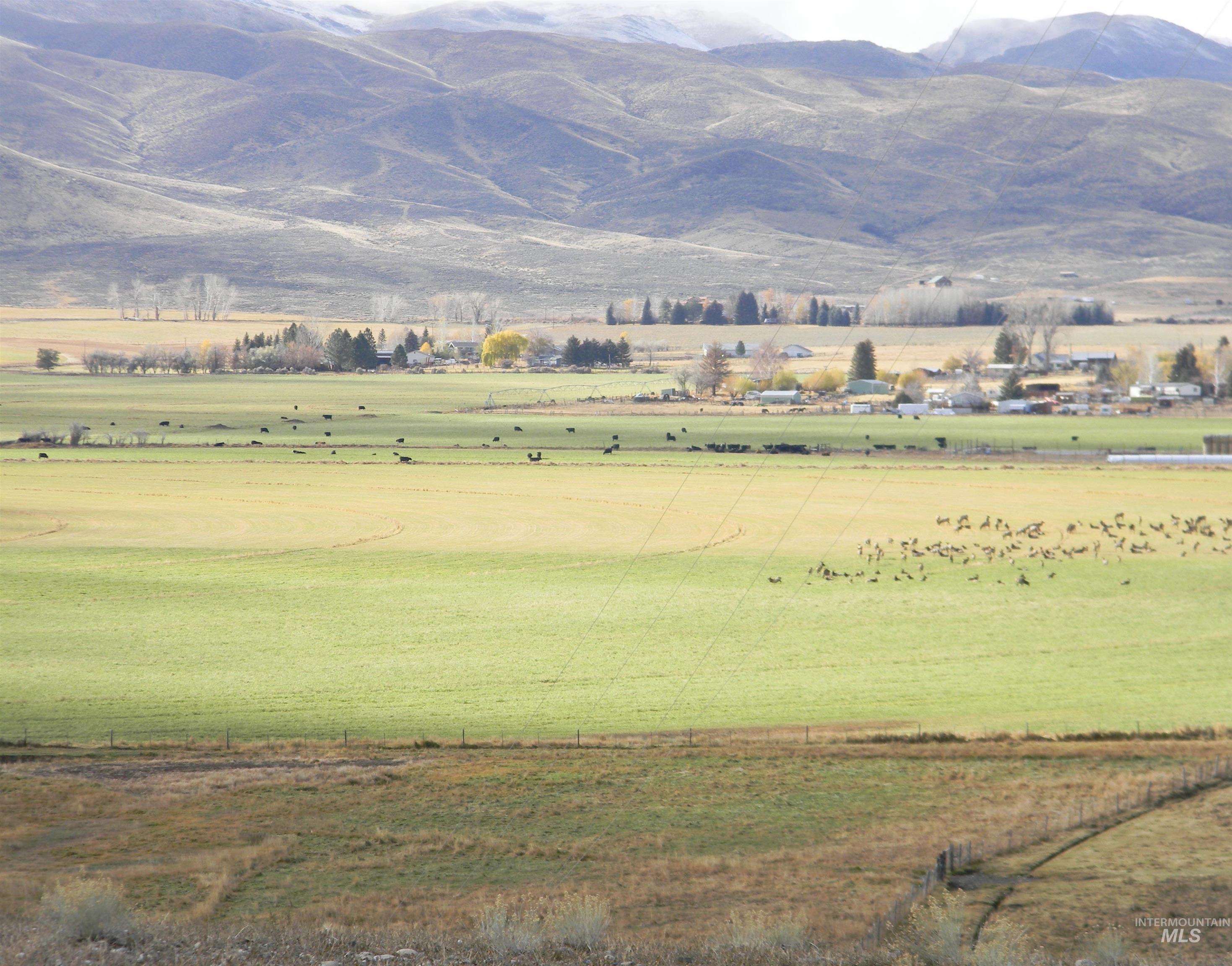 View of mountain backdrop with rural landscape
