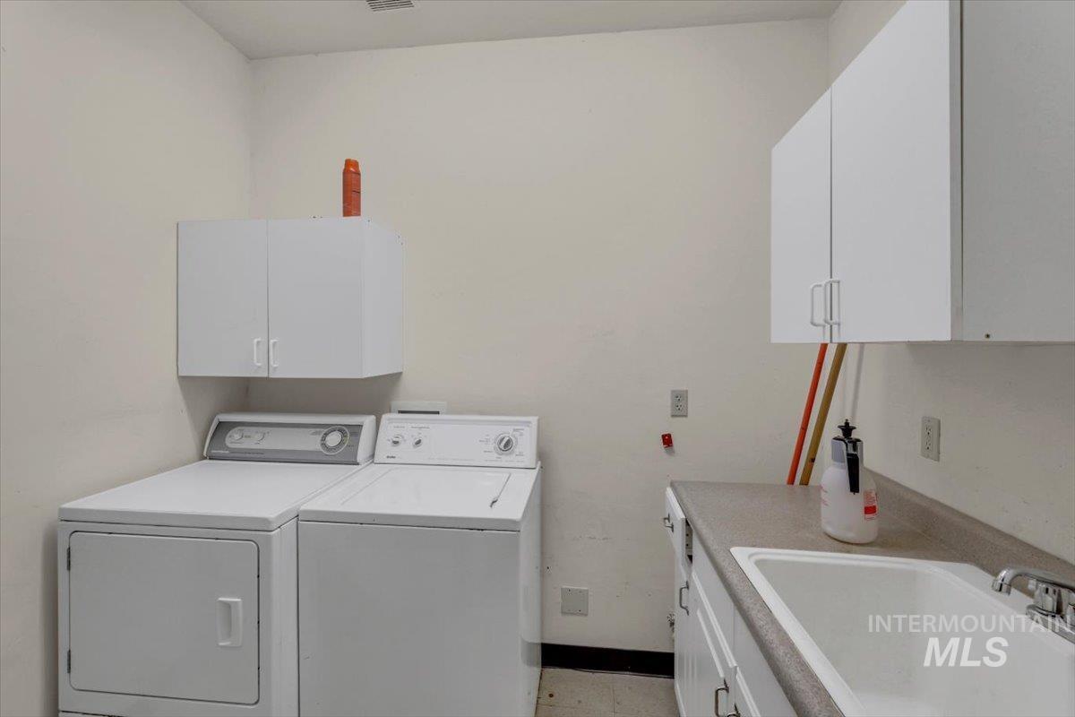 Laundry room with washer and dryer and cabinet space