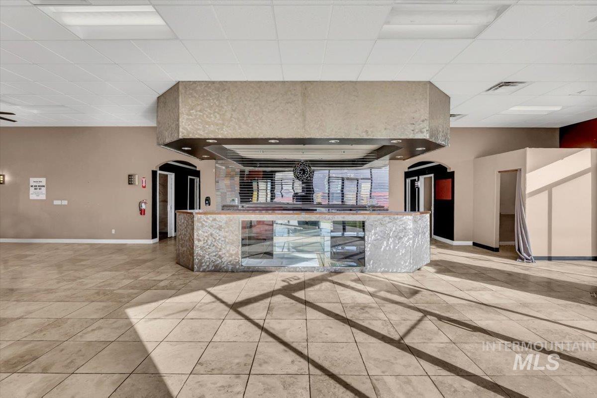 Kitchen featuring arched walkways and a paneled ceiling