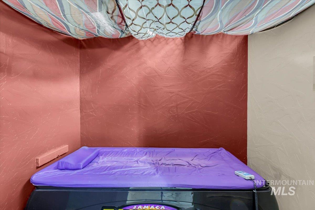 Bedroom featuring a textured wall