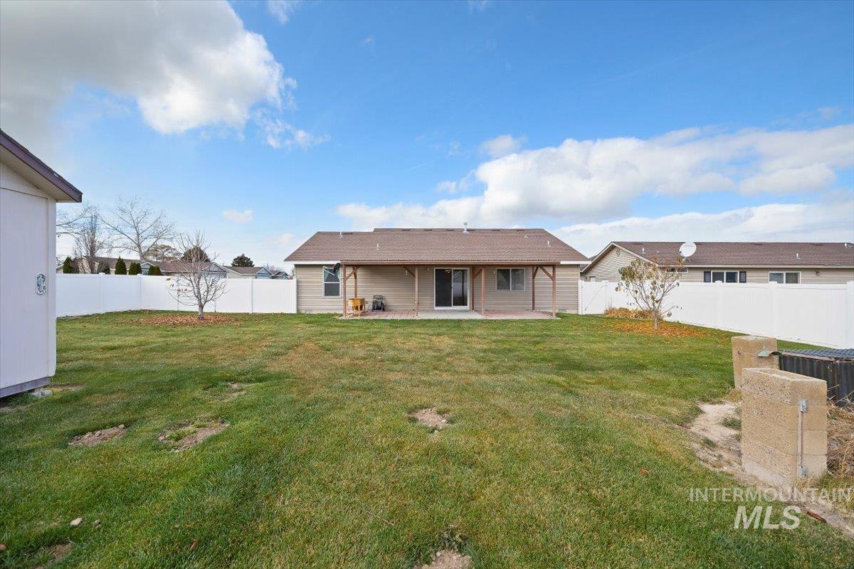 Rear view of property with a patio area and a fenced backyard