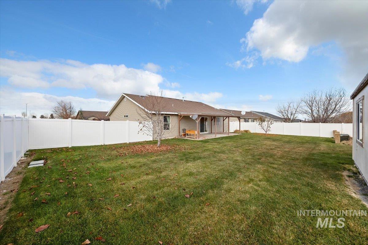 Back of property with a fenced backyard and a patio area