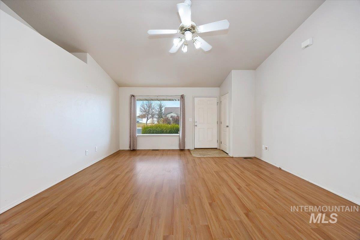 Spare room with light wood-type flooring and ceiling fan