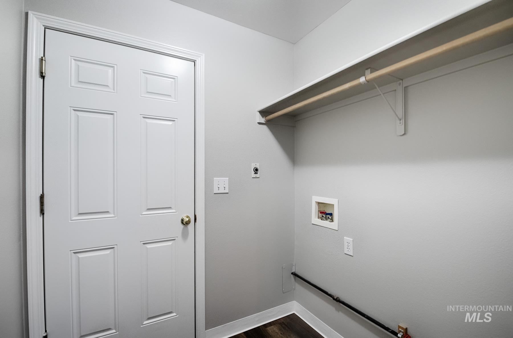 Laundry area featuring hookup for a washing machine and dark wood-style floors
