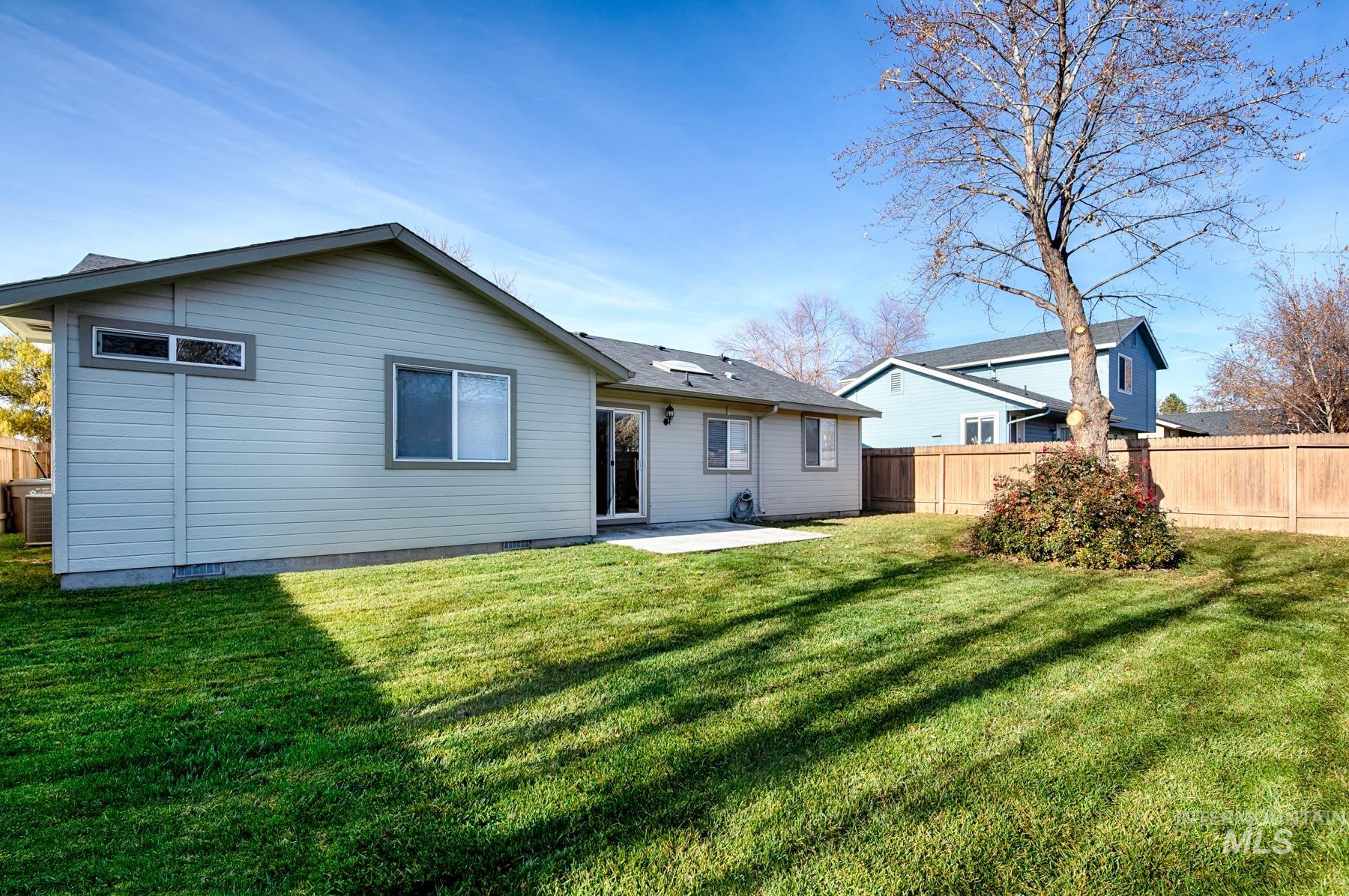 Rear view of property featuring a patio area and crawl space