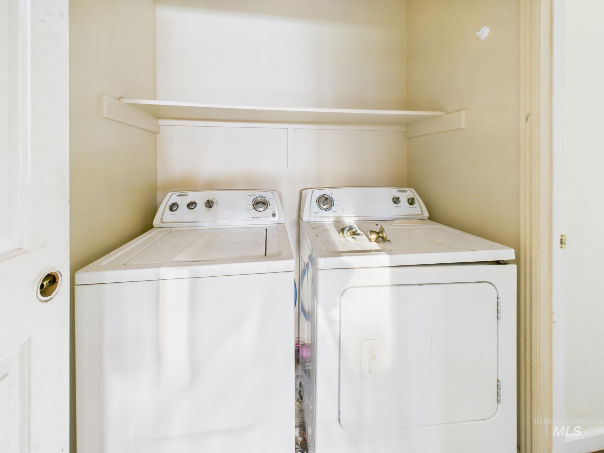 Laundry area with washing machine and clothes dryer