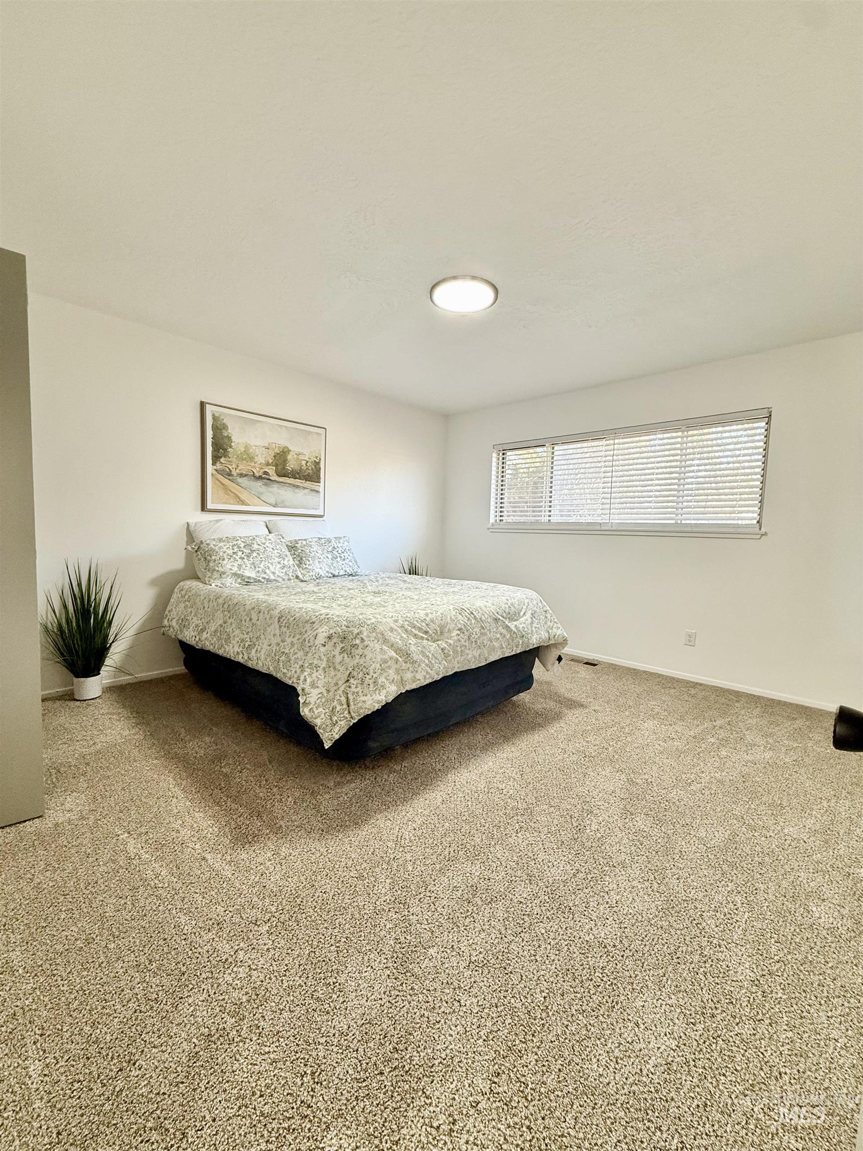 Bedroom featuring carpet flooring and baseboards