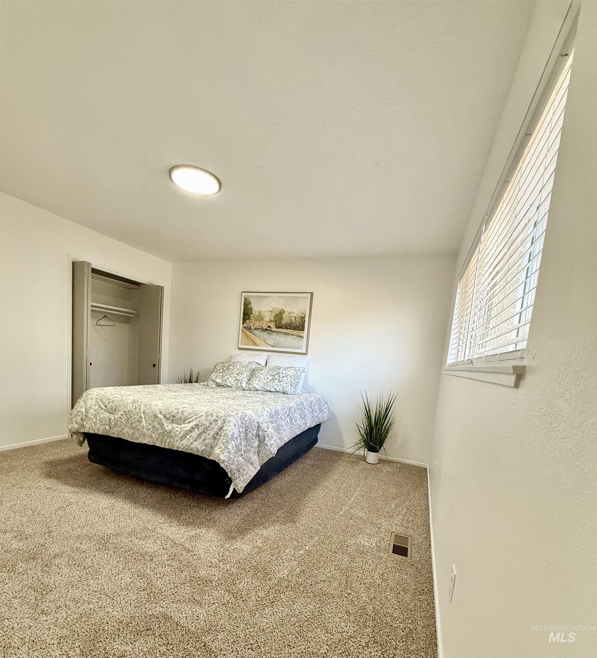 Bedroom with carpet and a closet