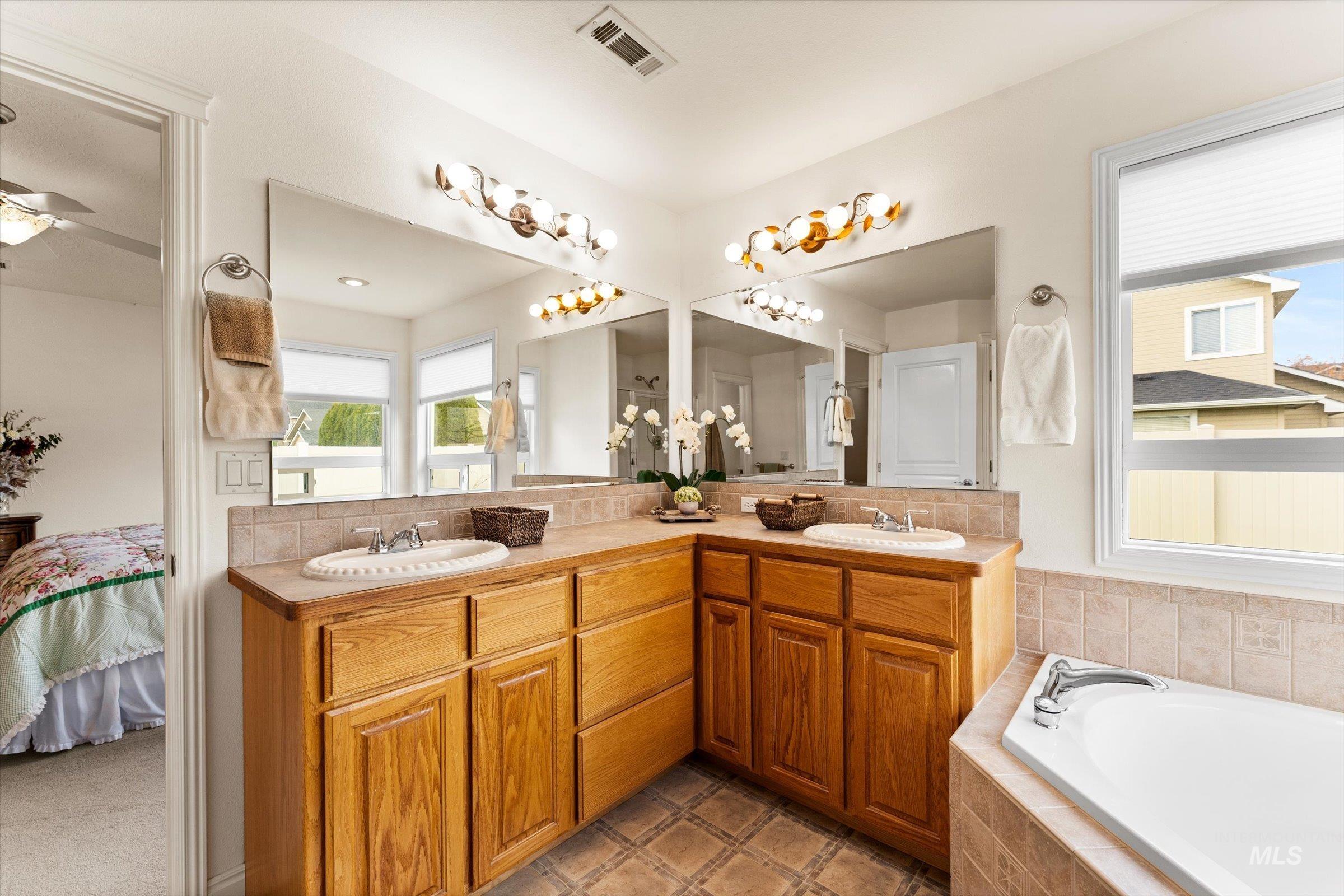 Ensuite bathroom with double vanity and a garden tub
