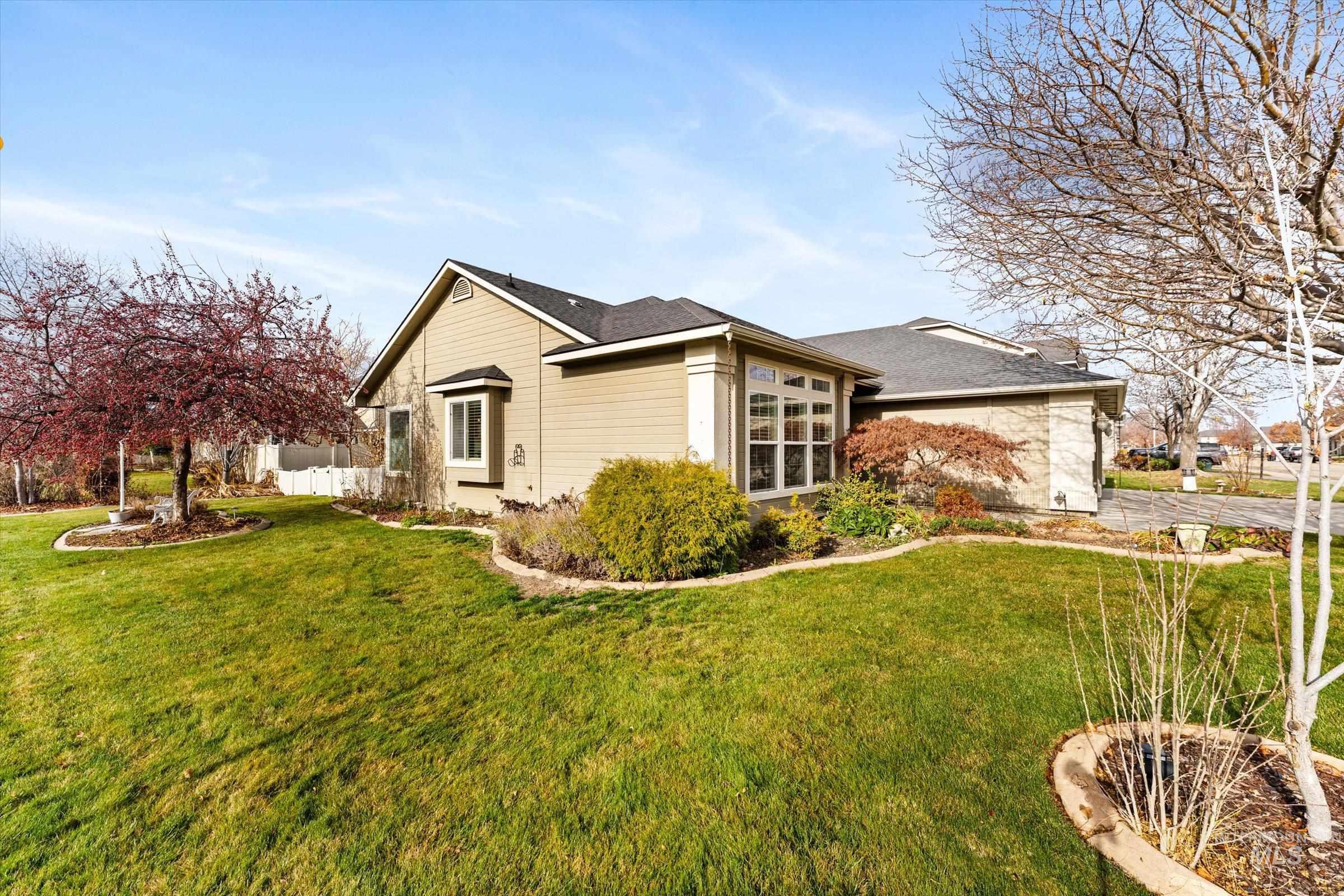 View of side of property with roof with shingles