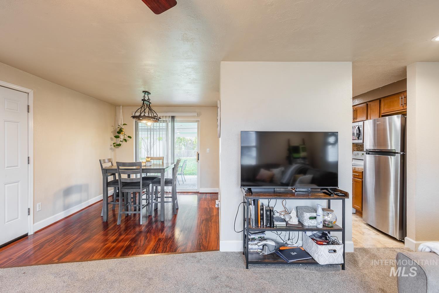 Dining space featuring light colored carpet and light wood-type flooring