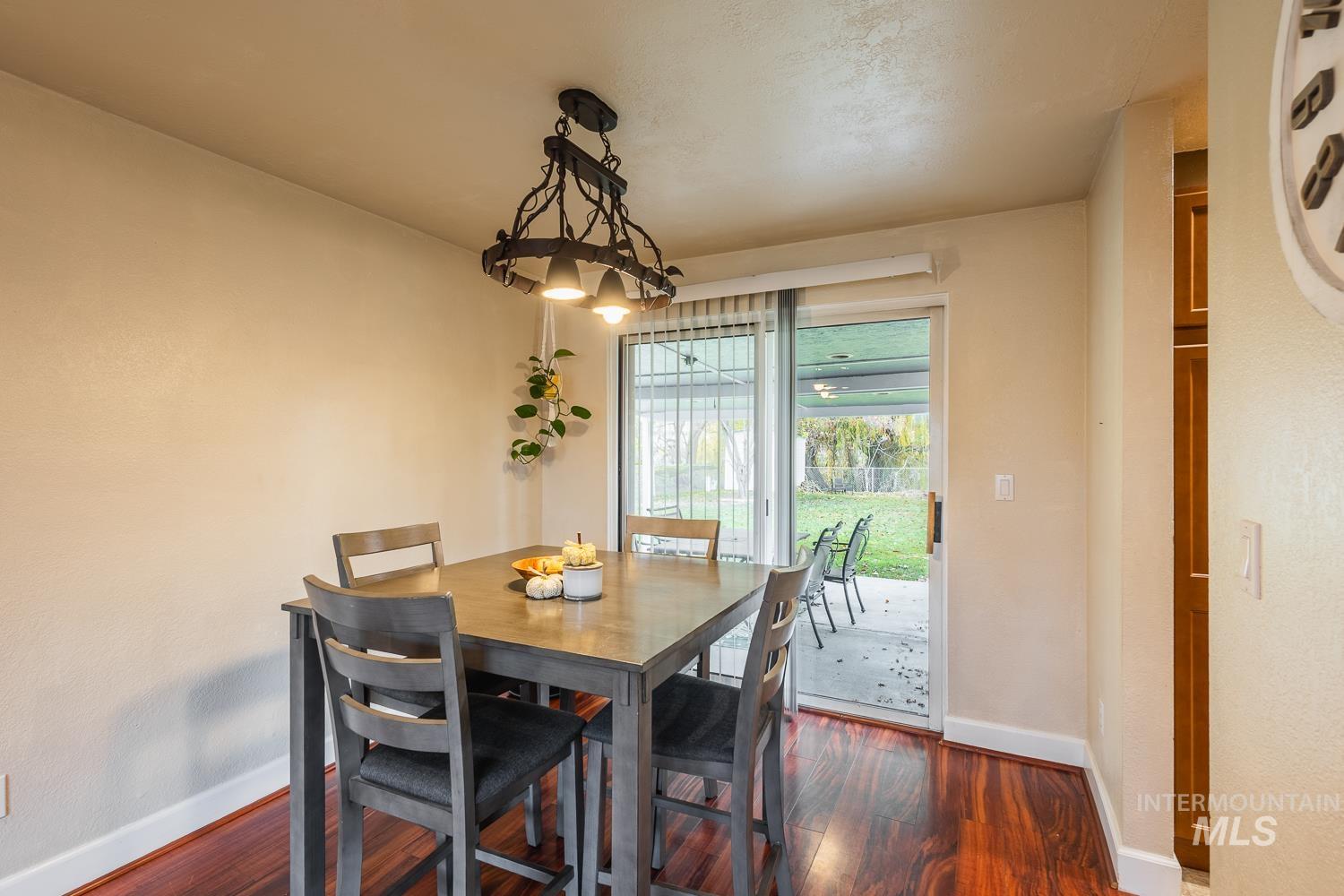 Dining space featuring dark wood-type flooring and baseboards