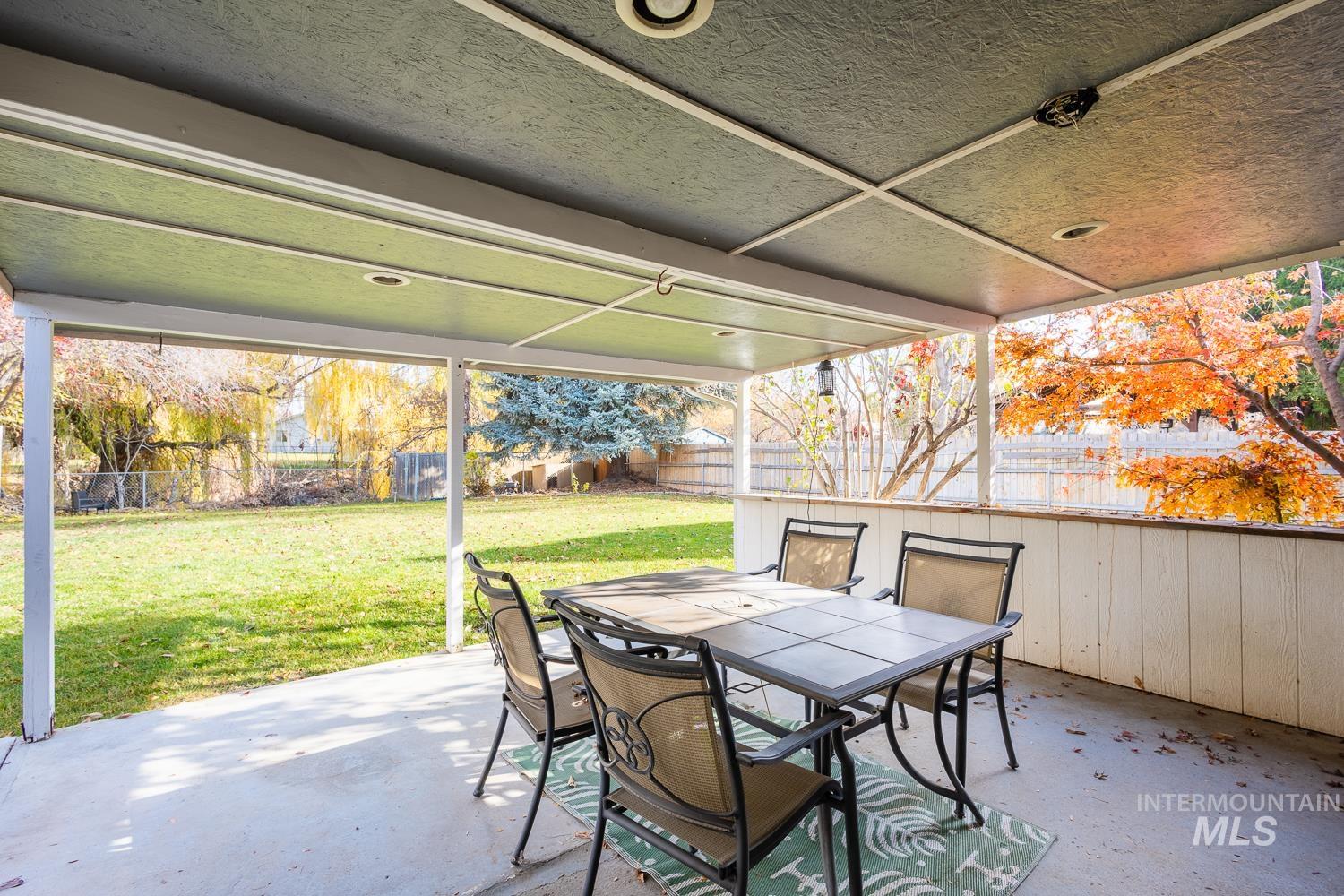 Fenced backyard with outdoor dining space and a patio area