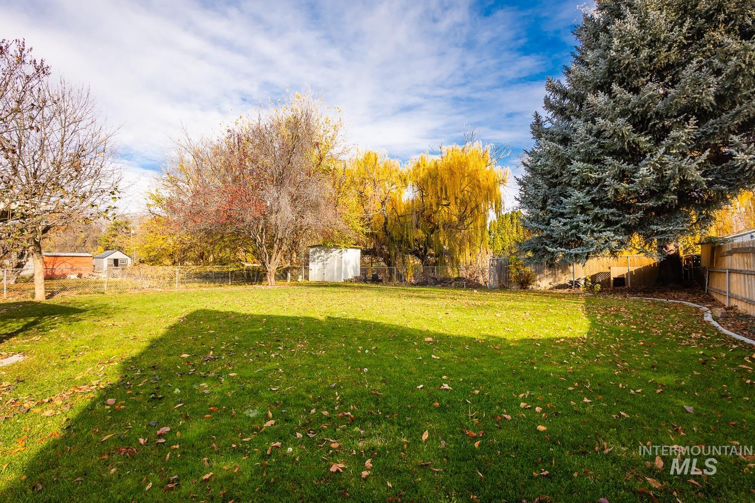 Fenced backyard with a storage shed