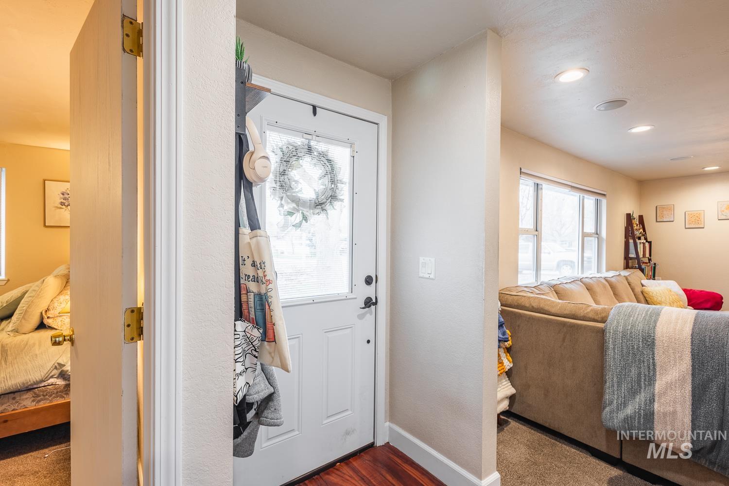 Entrance foyer featuring dark wood finished floors and recessed lighting