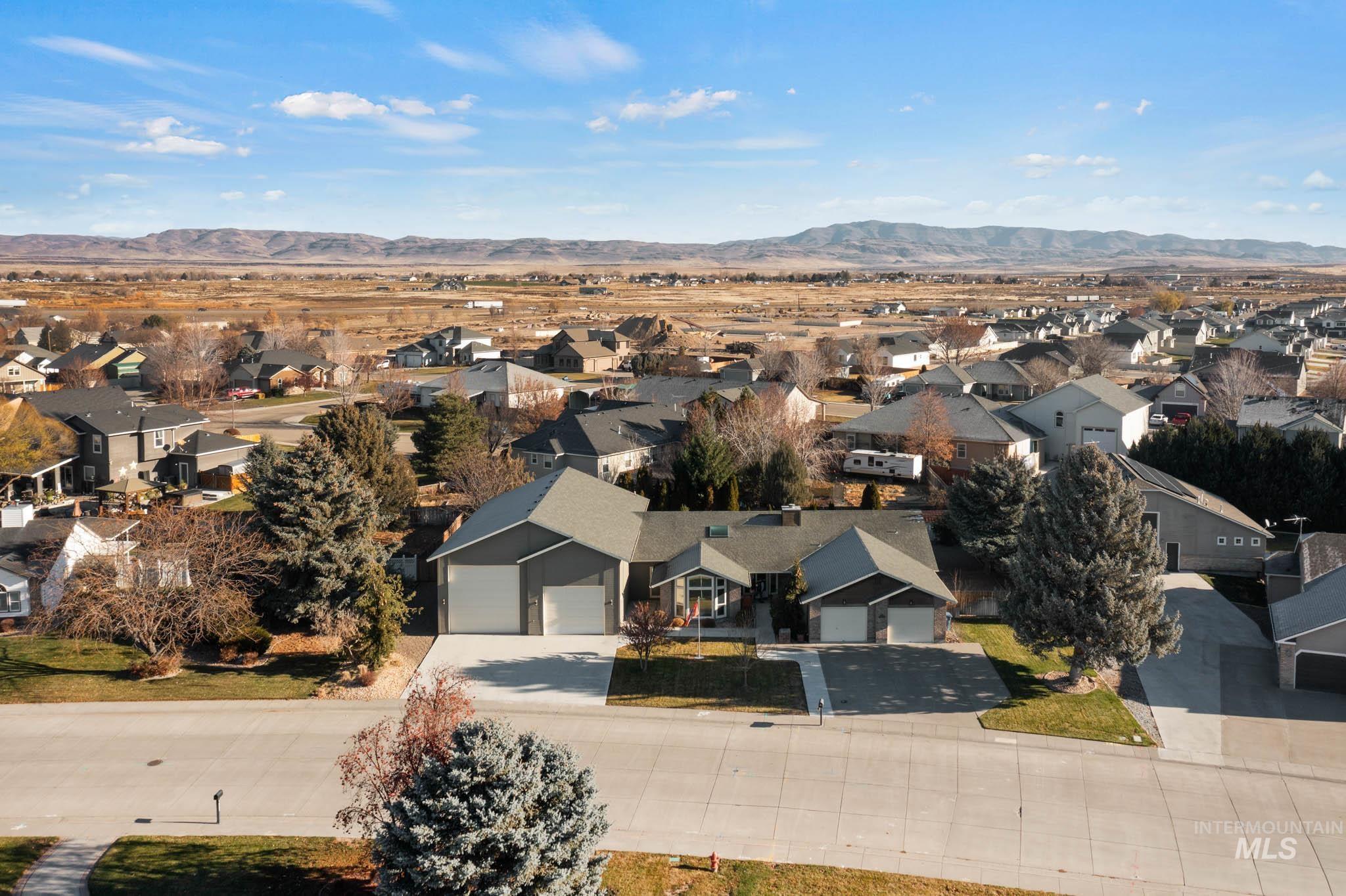 Aerial view of residential area featuring a mountain backdrop
