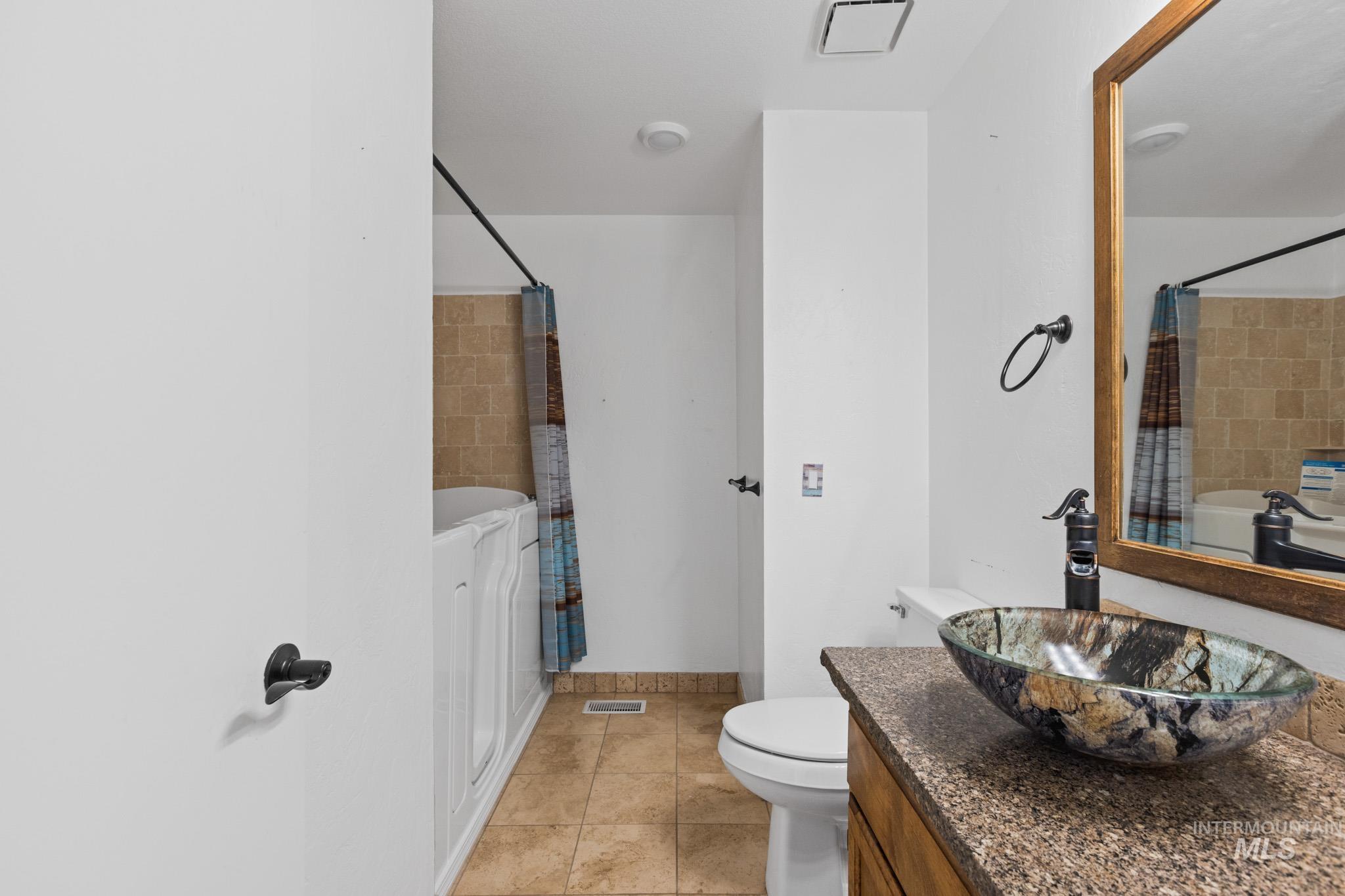 Bathroom with vanity and light tile patterned floors