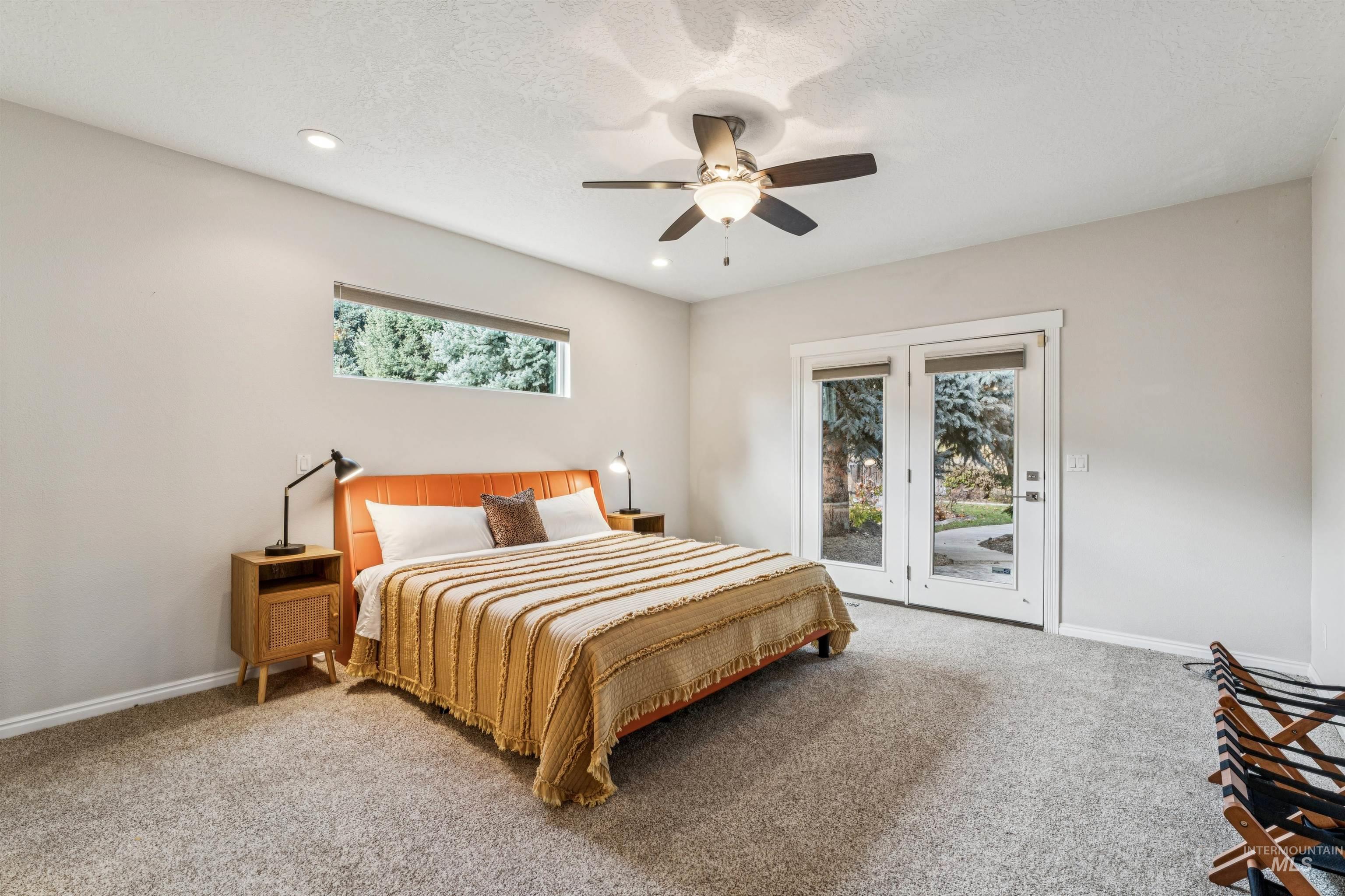 Carpeted bedroom featuring access to outside, ceiling fan, and recessed lighting