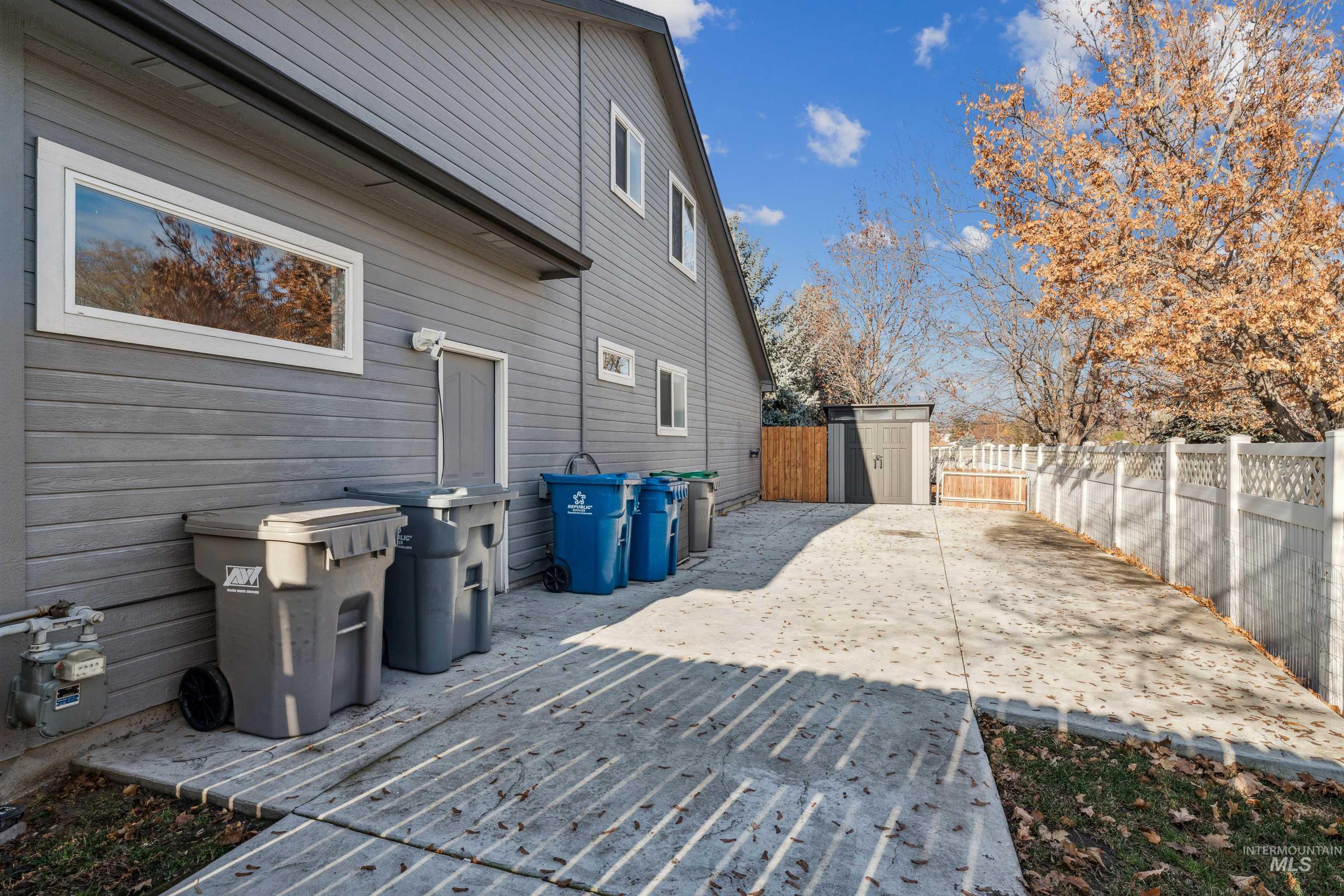 Deck featuring a storage unit, a fenced backyard, and a patio area