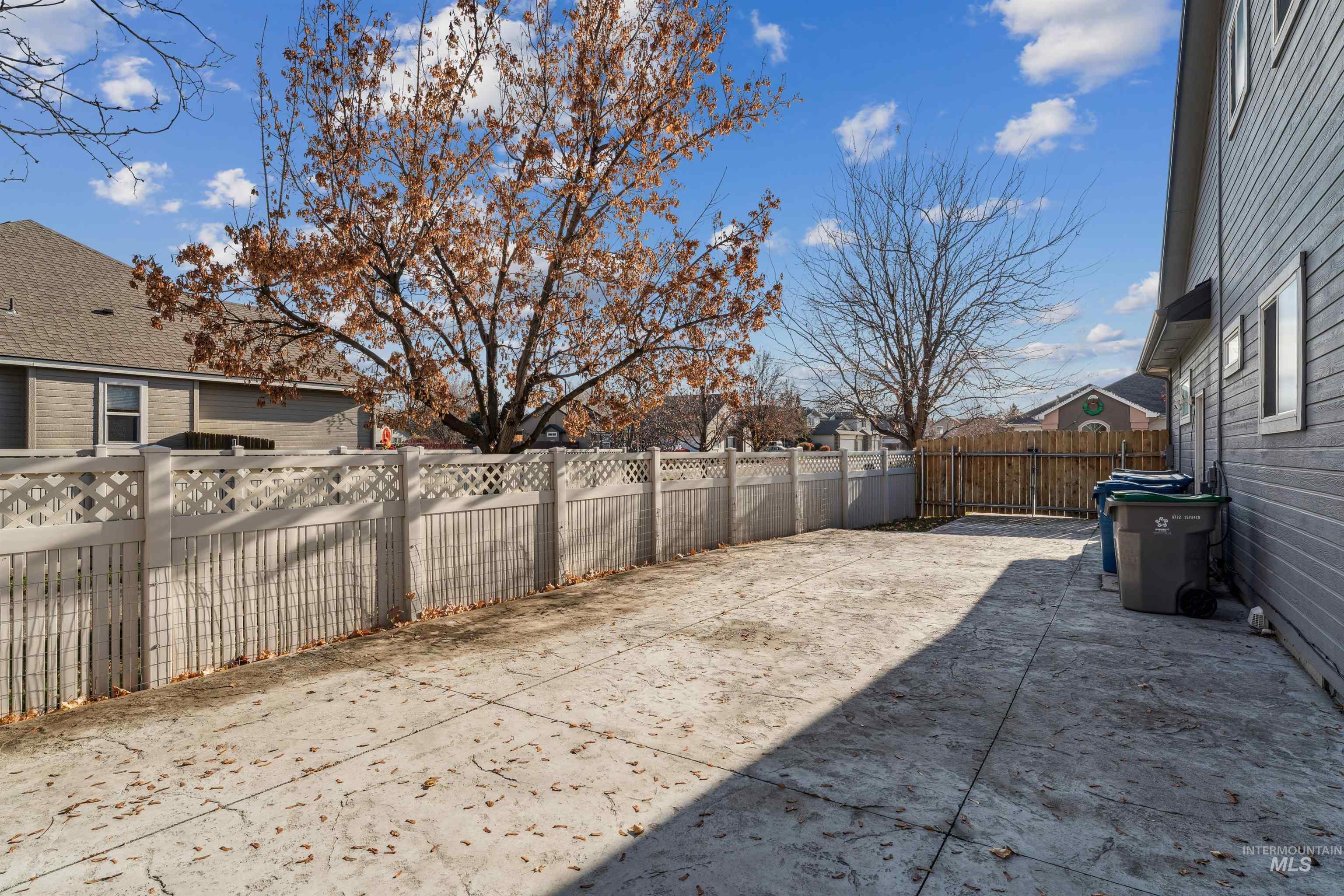 Fenced backyard with a patio