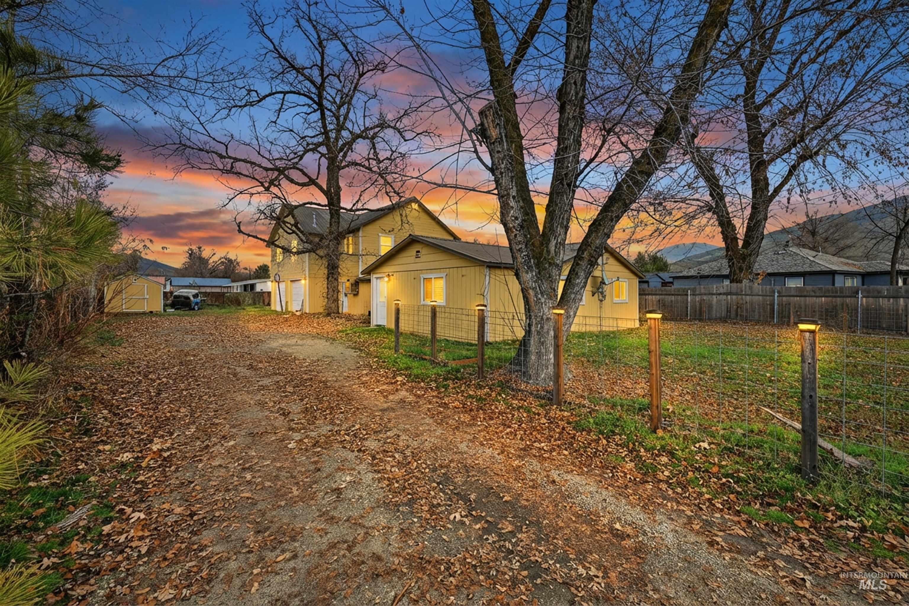 View of front of property featuring dirt driveway