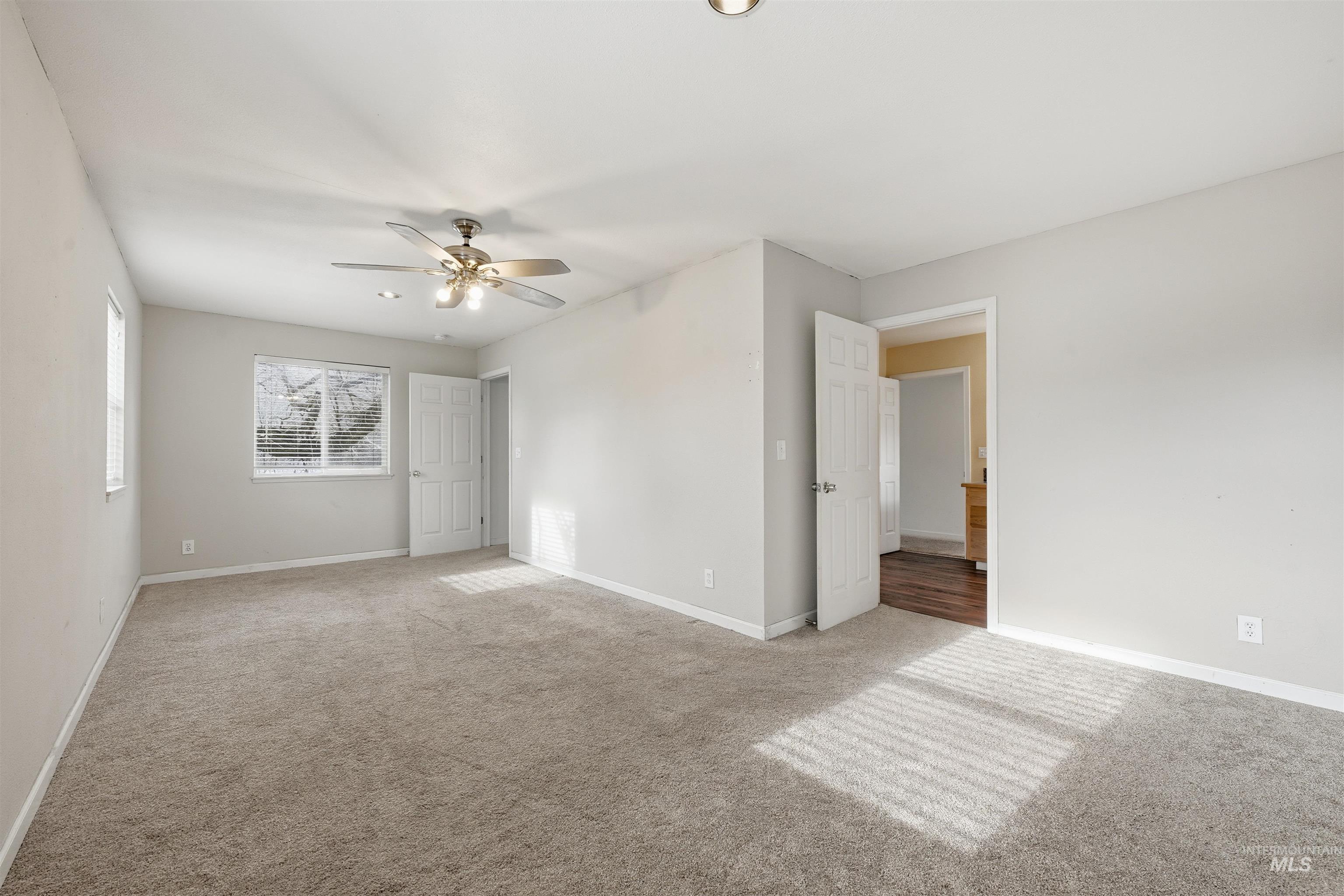 Unfurnished bedroom featuring carpet flooring and a ceiling fan