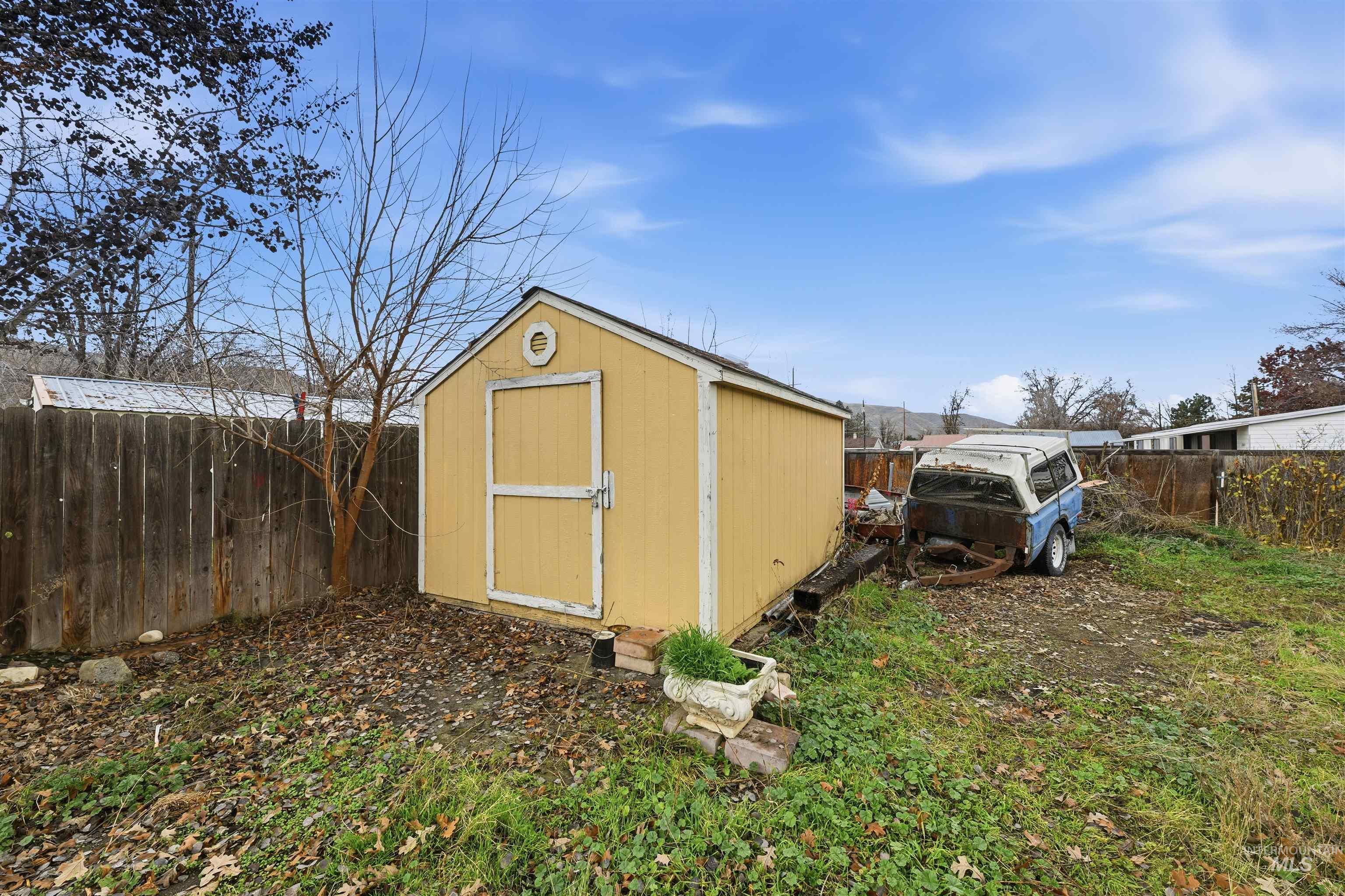 View of shed with a fenced backyard