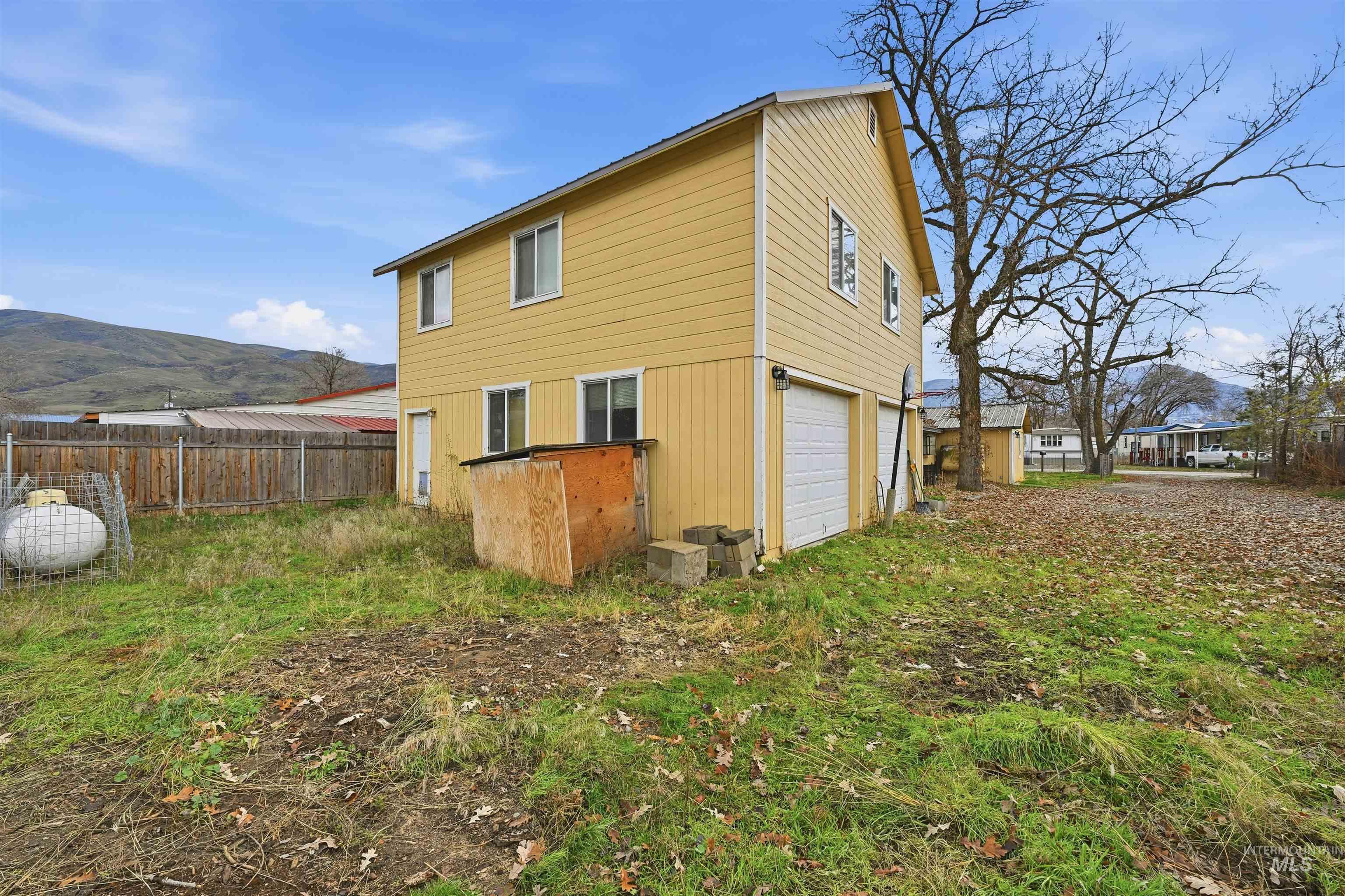 Back of property featuring a mountain view and a garage