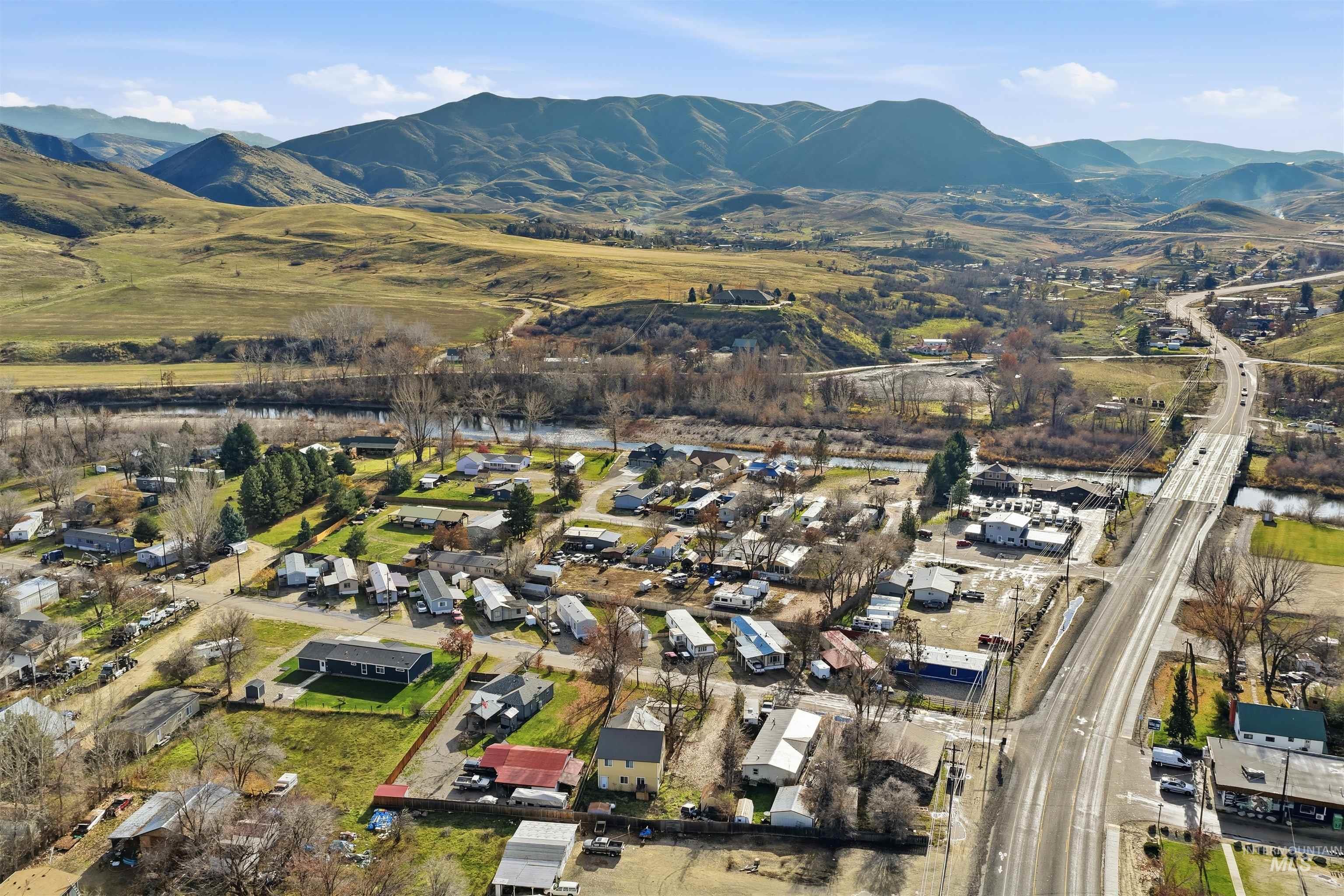 Aerial overview of property's location with mountains and nearby suburban area