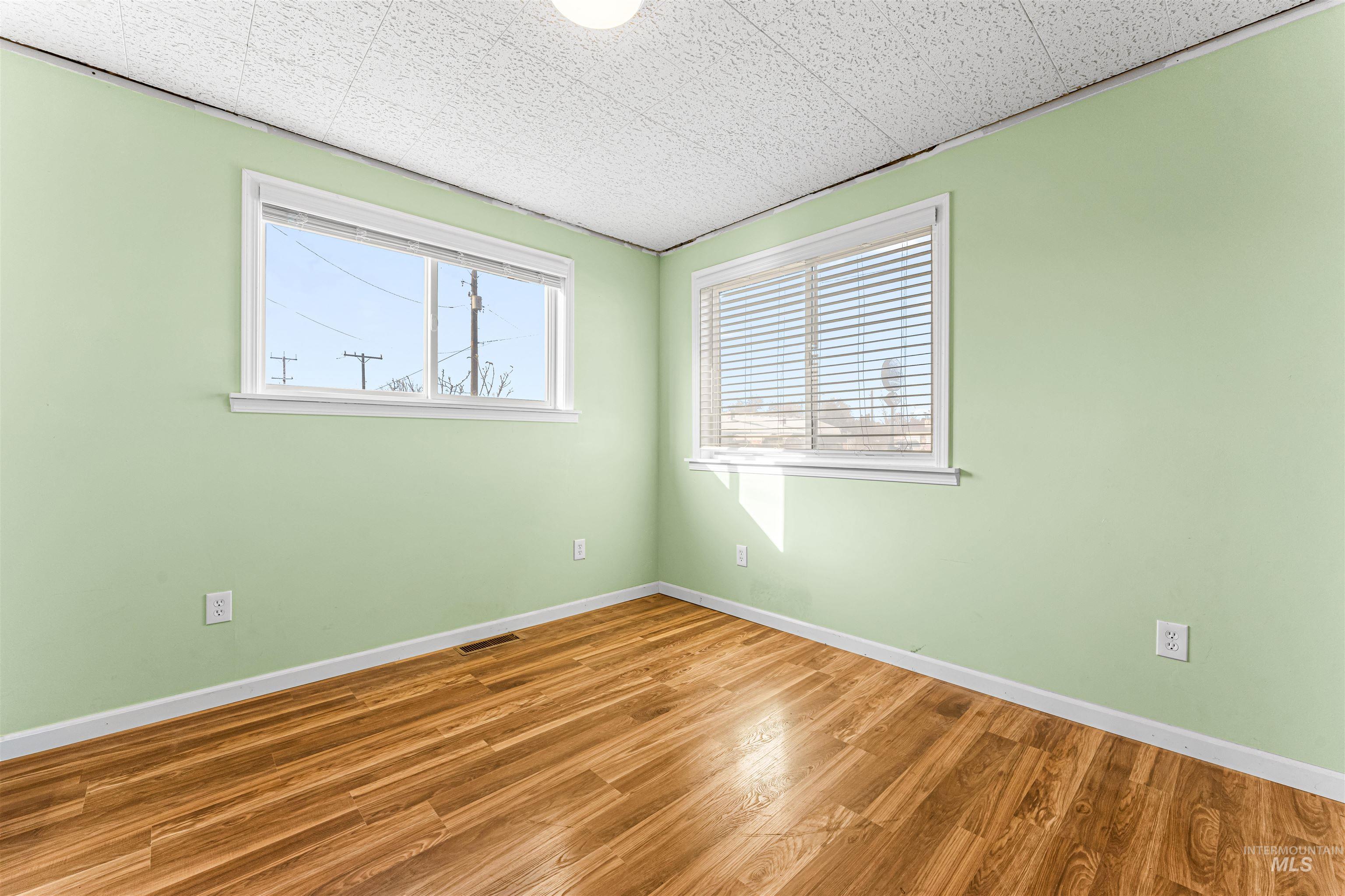 Spare room with wood finished floors and baseboards