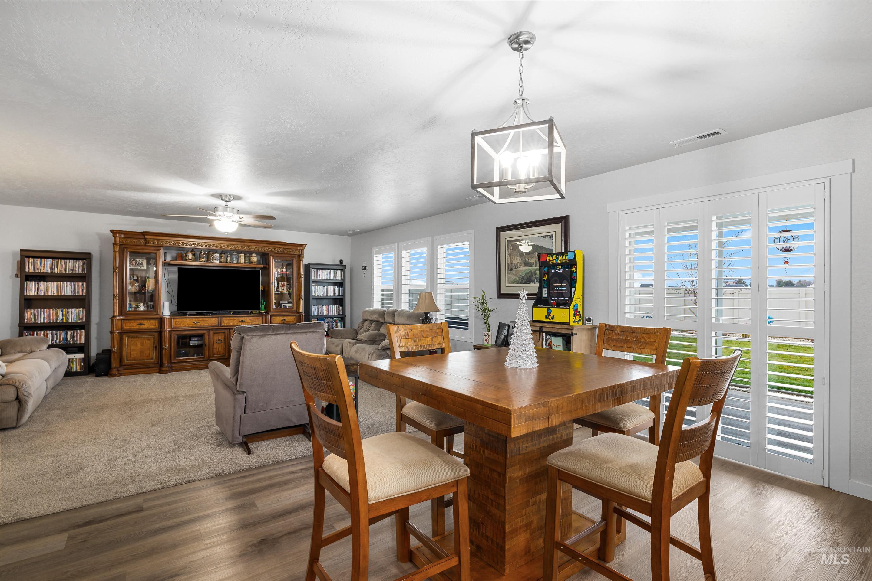 Dining space featuring wood finished floors and ceiling fan